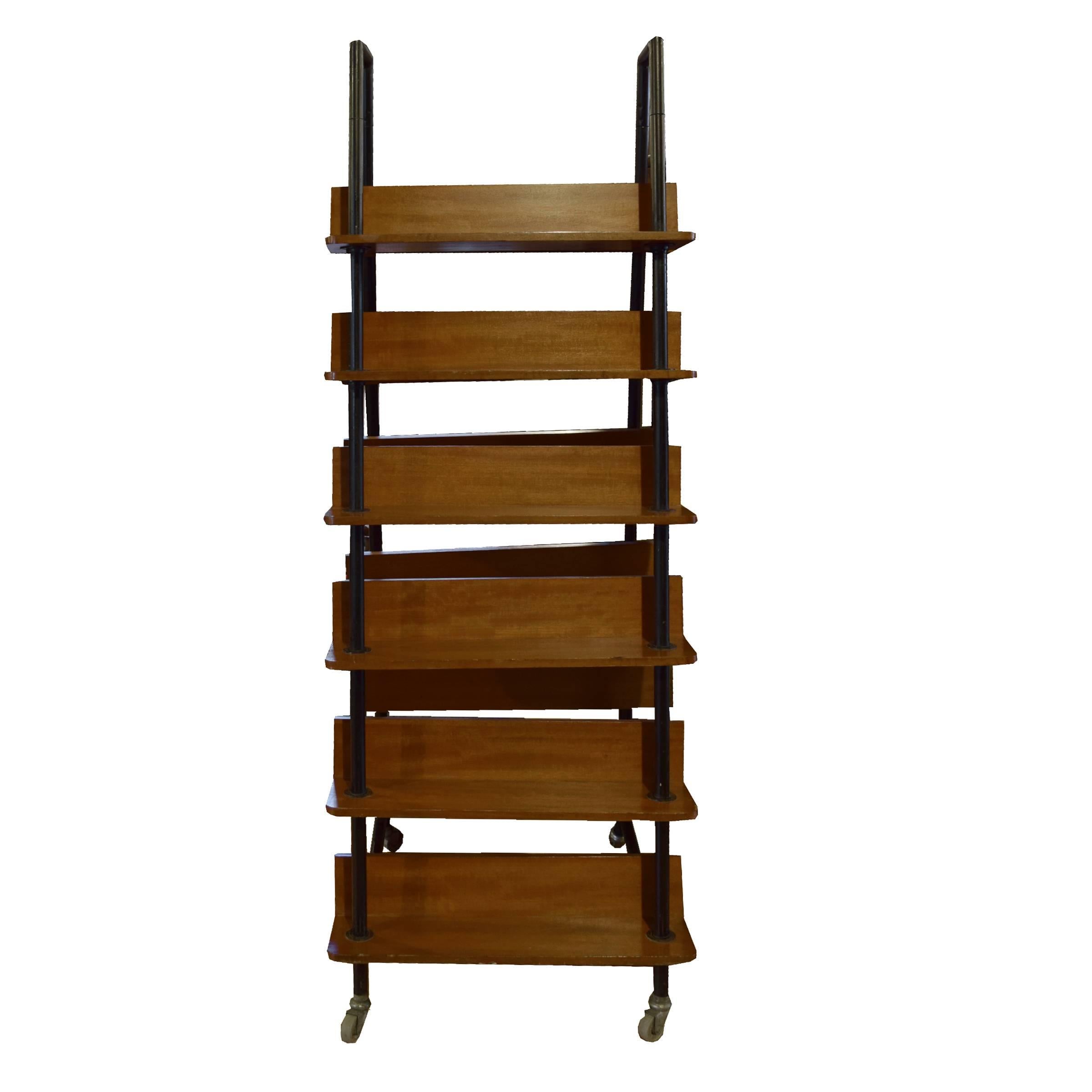 A French midcentury double-sided freestanding bookshelf on casters, with 12 shelves on a metal frame.