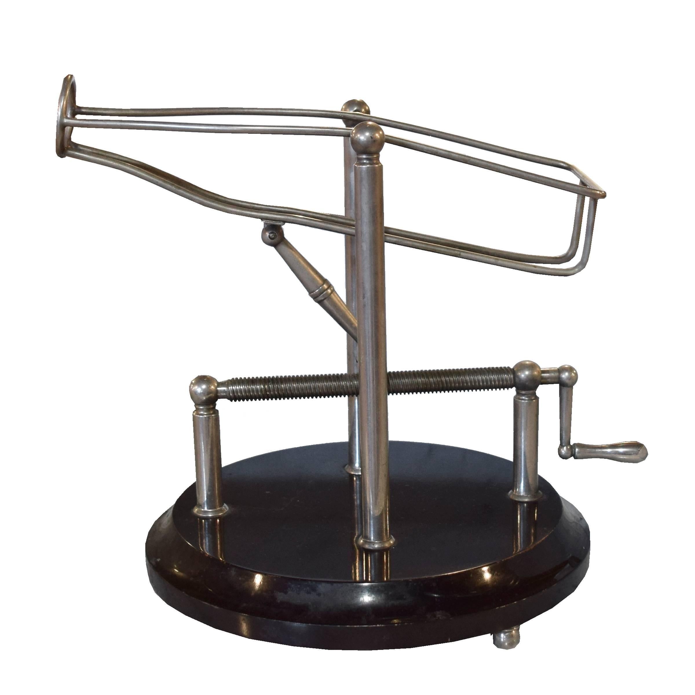 A fantastic French wine decanting cradle with a brass bottle cradle and wood base with brass feet. Turning the handle activates the cradle, bringing it forward and tilting it to achieve the perfect angle for pouring while keeping any sediment in the