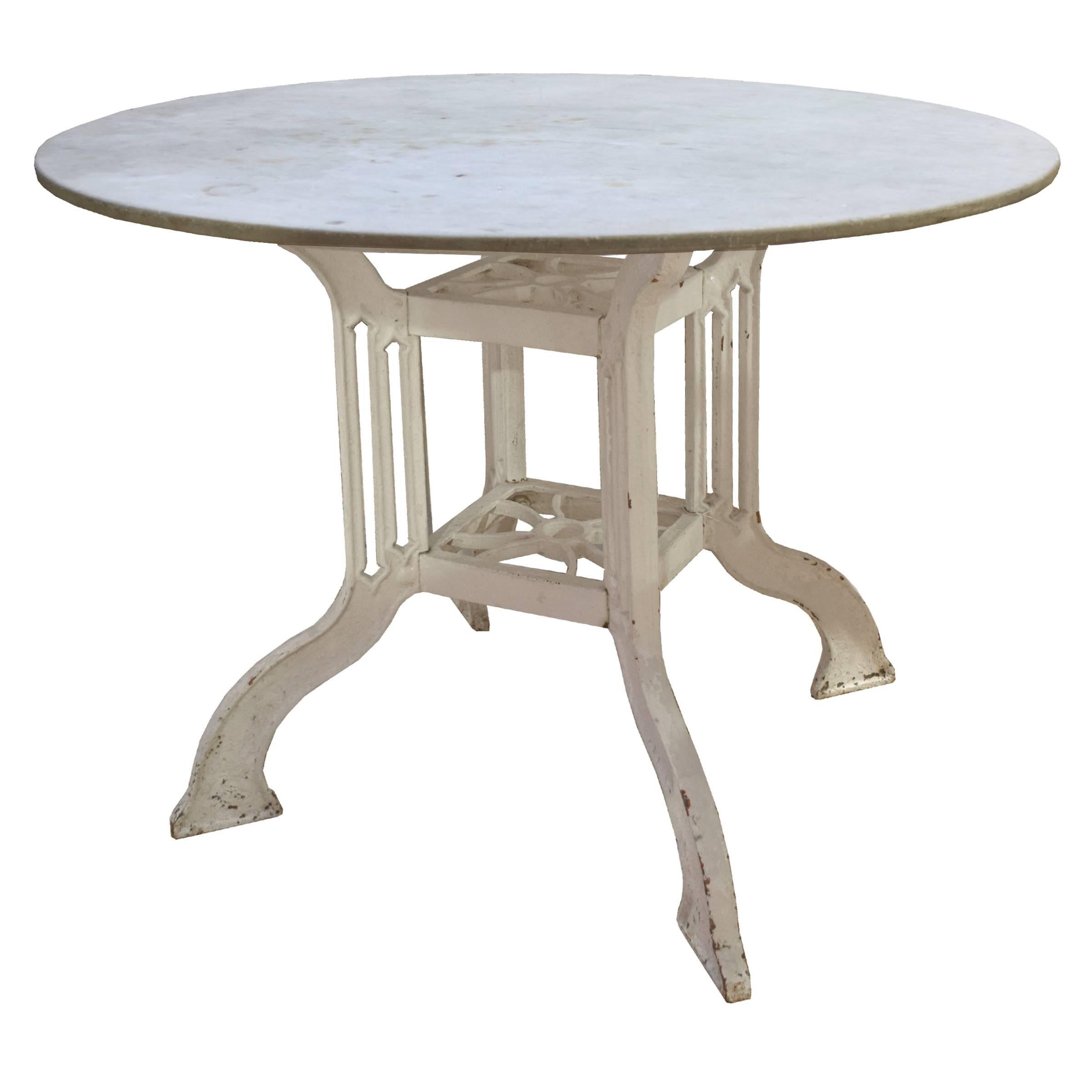 A lovely French café table with a painted iron table base with a round marble top, circa 1900.
