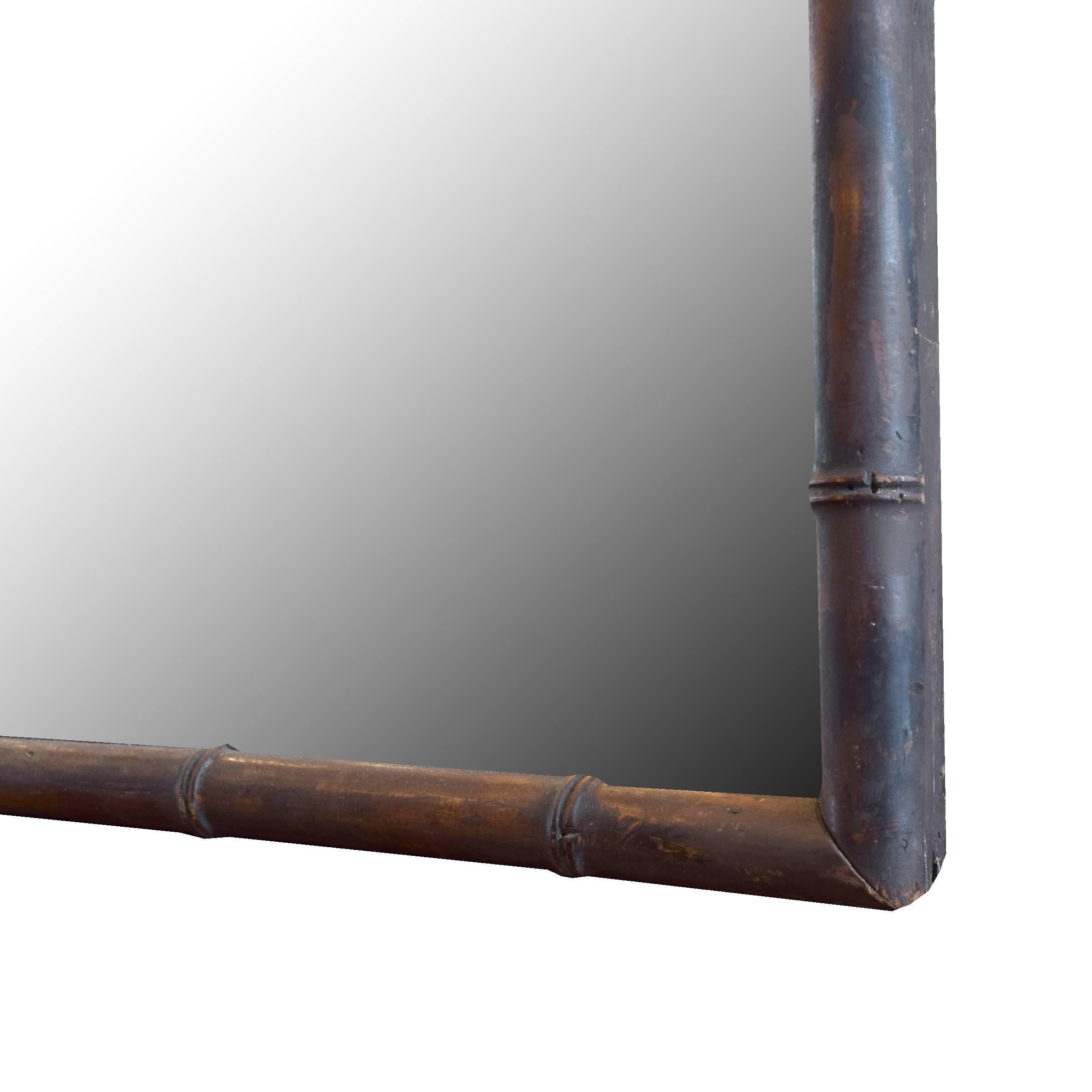 A tall French carved walnut frame, meant to mimic bamboo, with mirror and a great patina, circa 1920.
