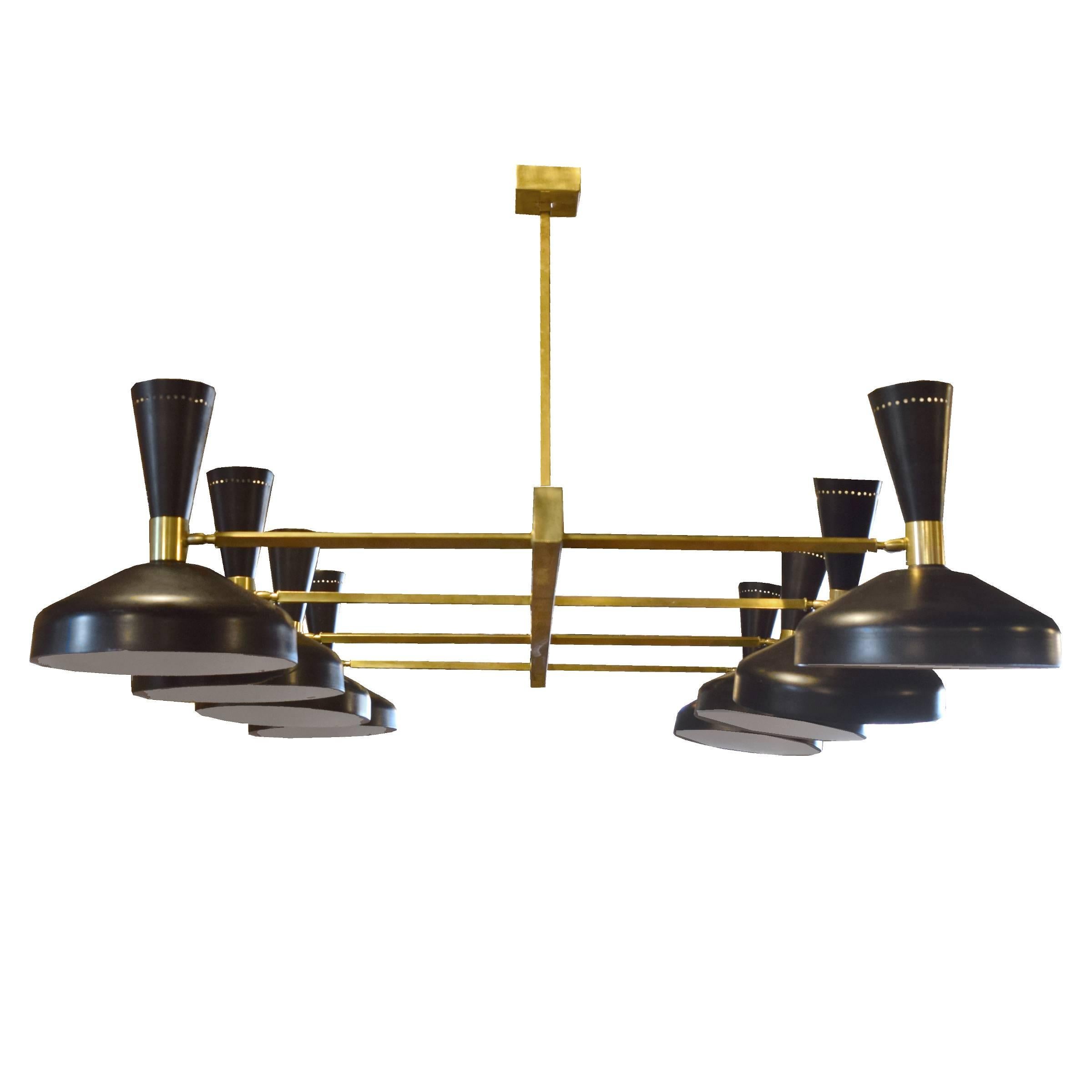 An Italian midcentury chandelier in the style of Stilnovo with brass downrods and eight arms with adjustable black enamel shades, each with up and down shining lights.
 Requires re-wiring.