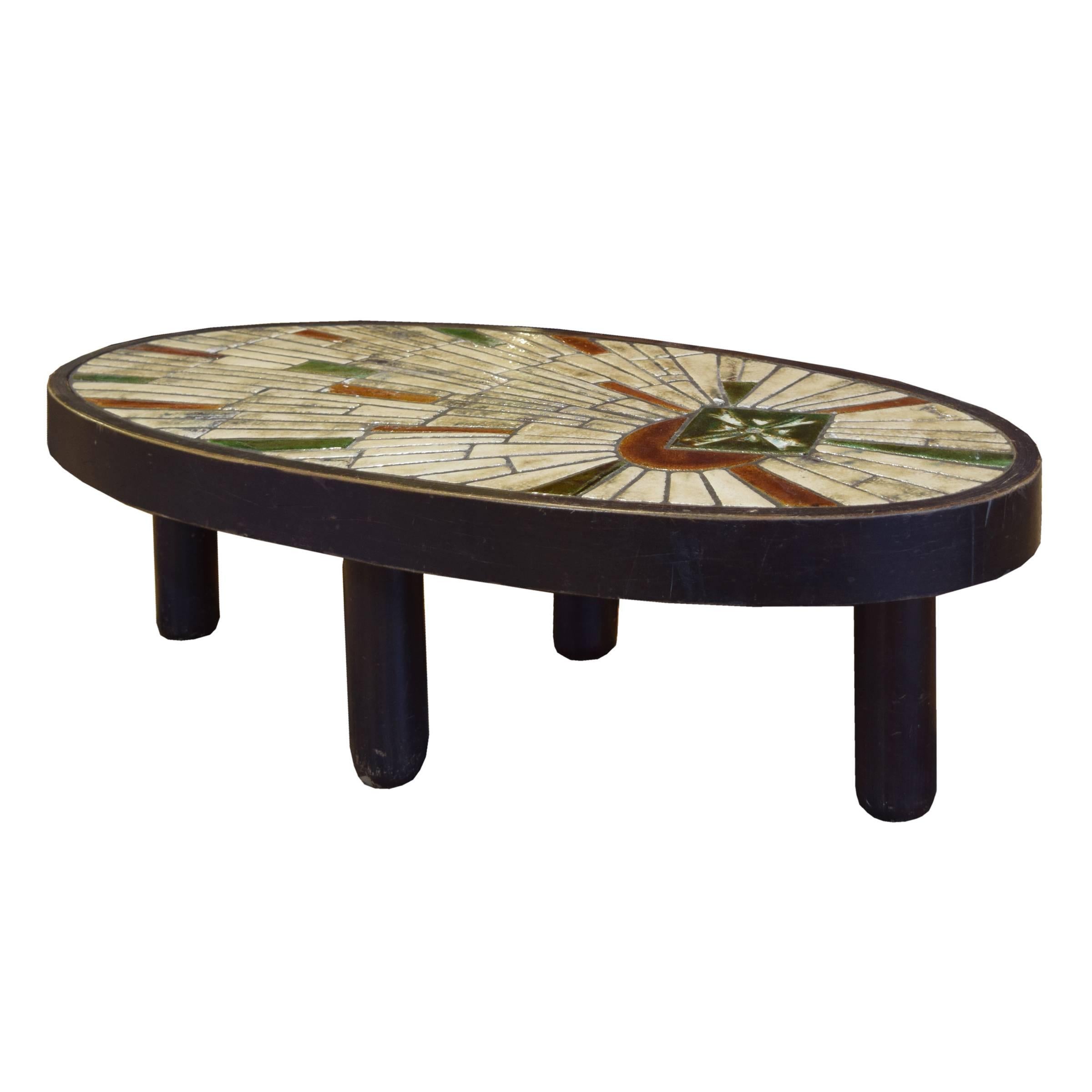 A fun midcentury wood oval table with four legs and a colorful mosaic tile-top by Barrois for Vallauris, signed 'Barrois'. Vallauris, on the southeastern coast of France, was also where Picasso developed his love of ceramics on the early 1950s.