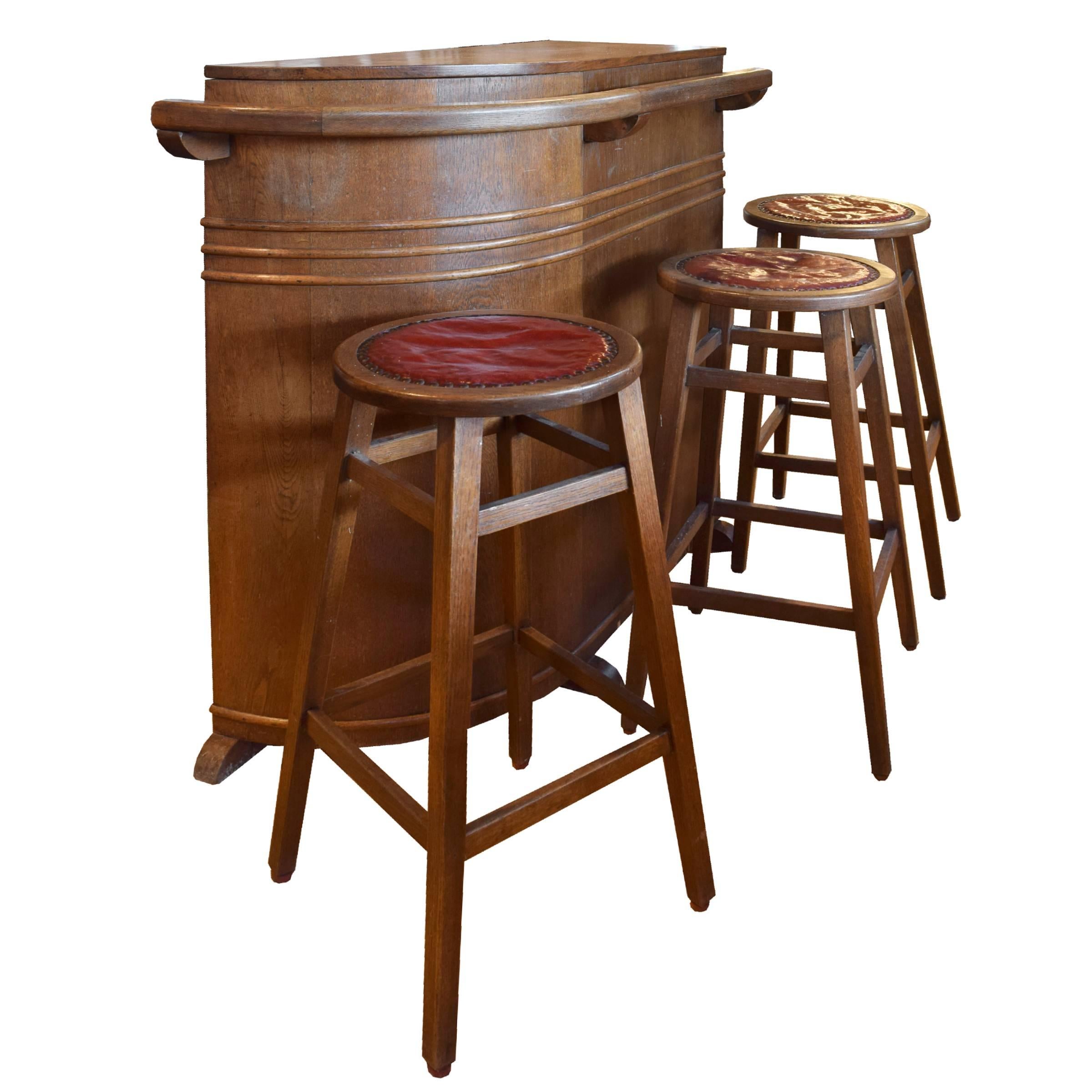 A fun French wood mid-century bar with a cool shape, shelves and storage in back, and three stools.
Stool height is 30 inches.