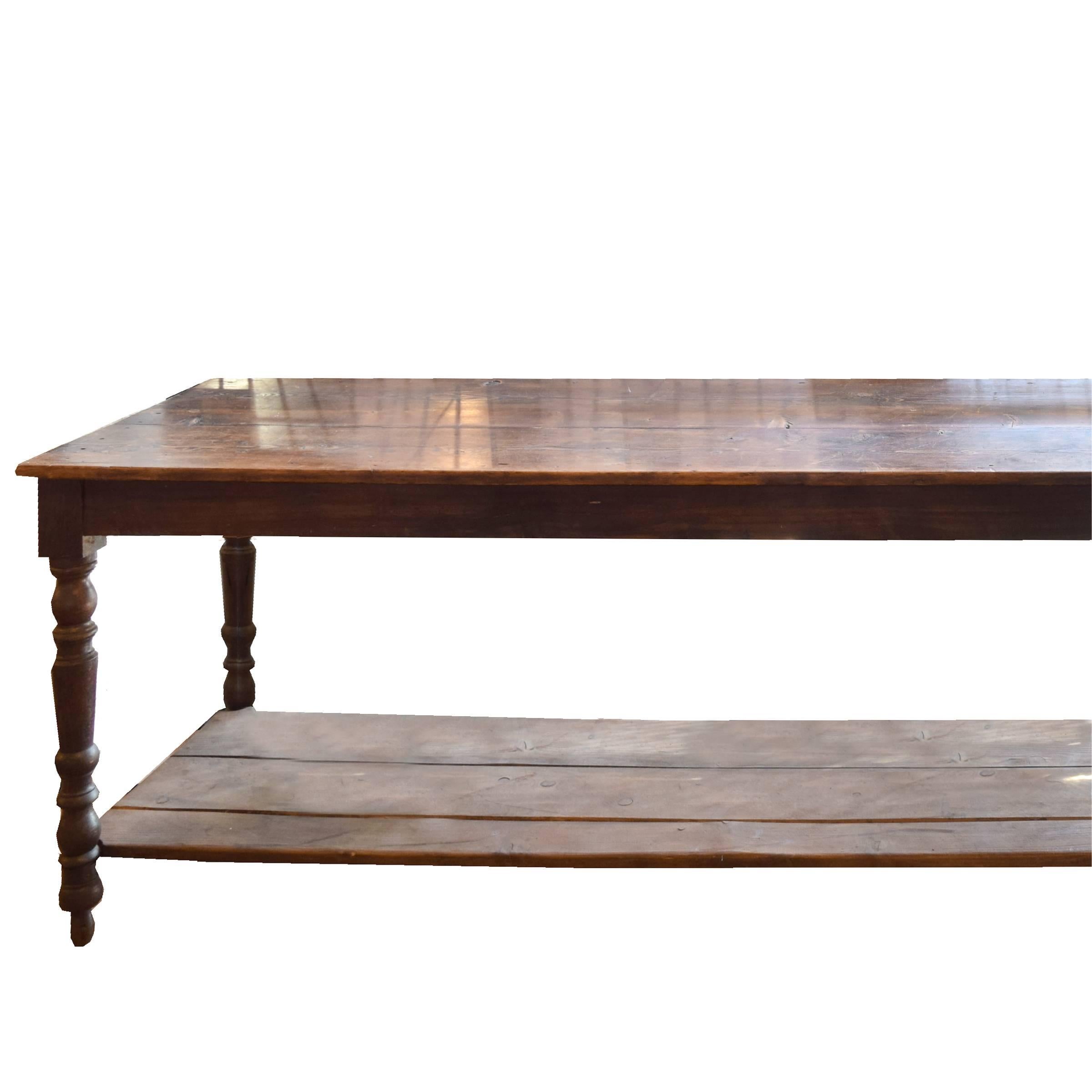 A fantastic monumental French wood draper's table with a low shelf and six turned legs, circa 1900.
