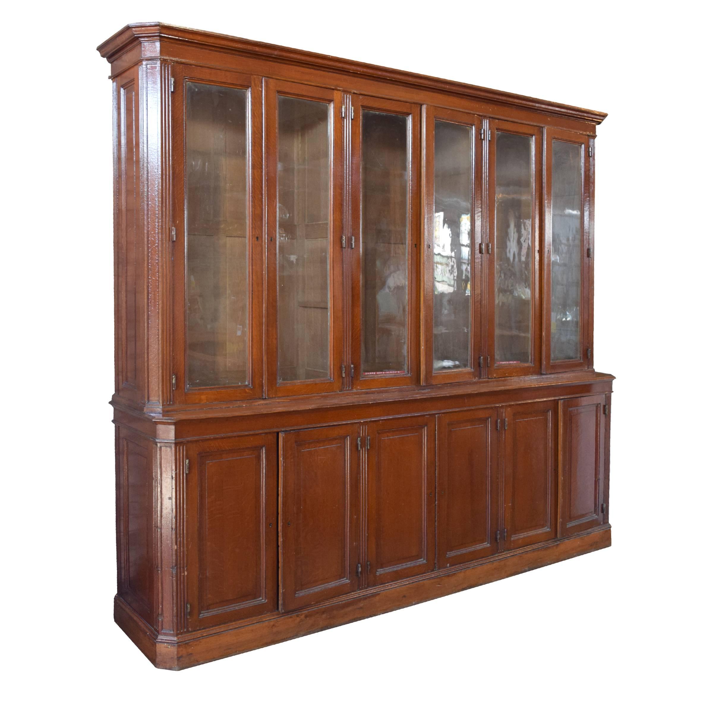 A fantastic French wood display cabinet with six glass doors on top and six wood doors on the bottom, and great hardware, circa 1900.