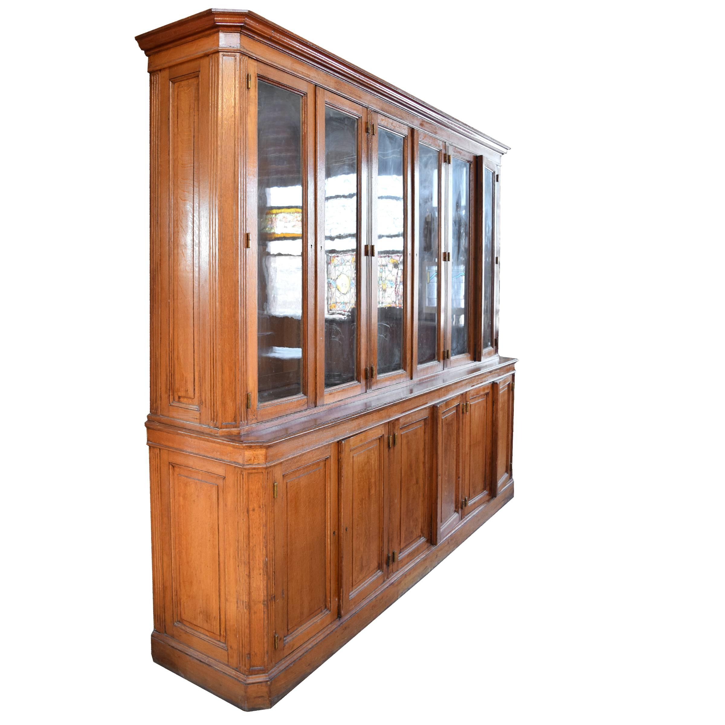 A fantastic French wood display cabinet with six glass doors on top and six wood doors on the bottom, and great hardware, circa 1900.