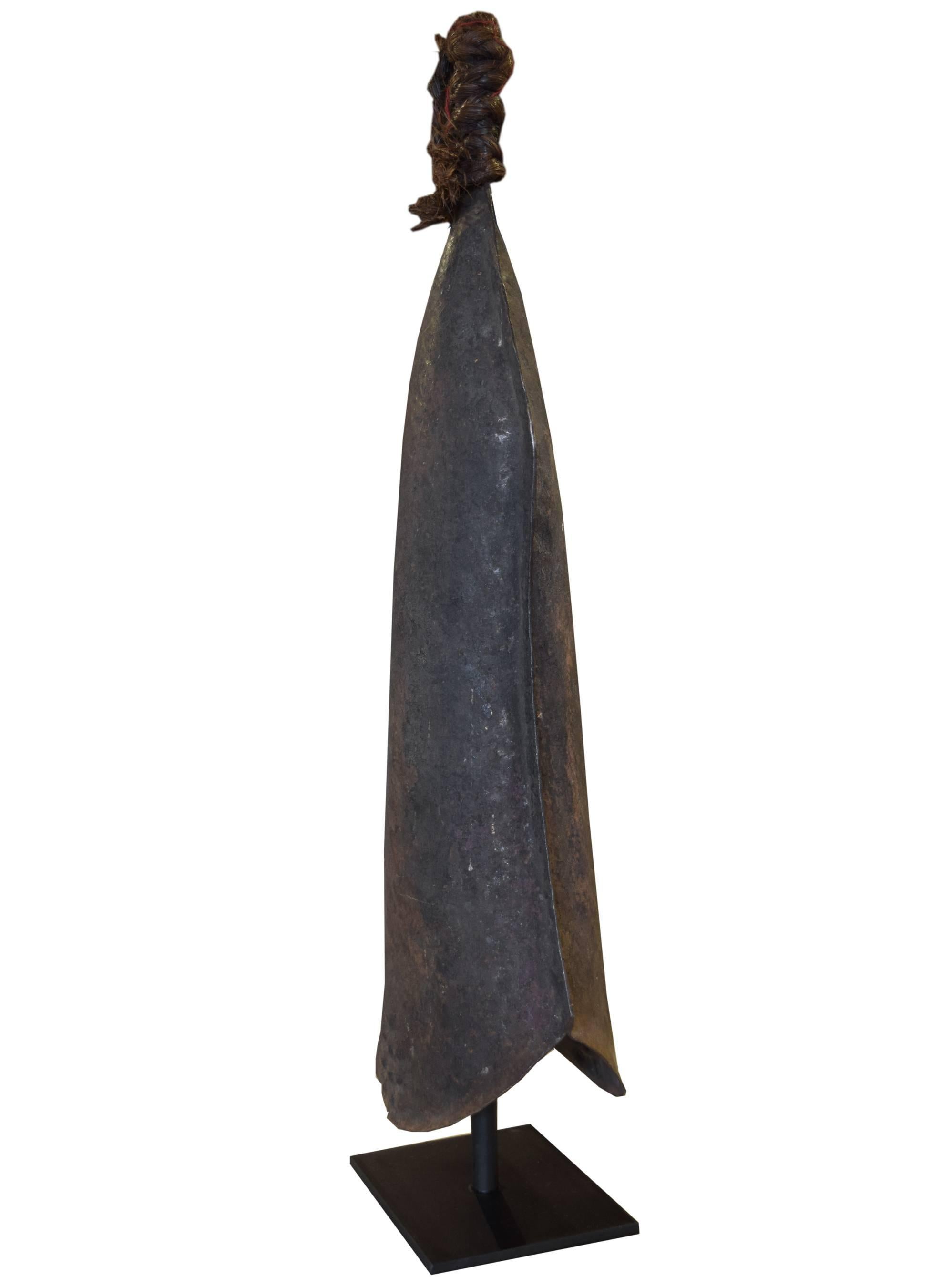 A hammered iron gong made by the blacksmiths of the Tetela & Onga peoples from the Congo. Gongs were important ritual instruments and symbols of authority. They were highly valued and thus used as currency for goods and even wives.