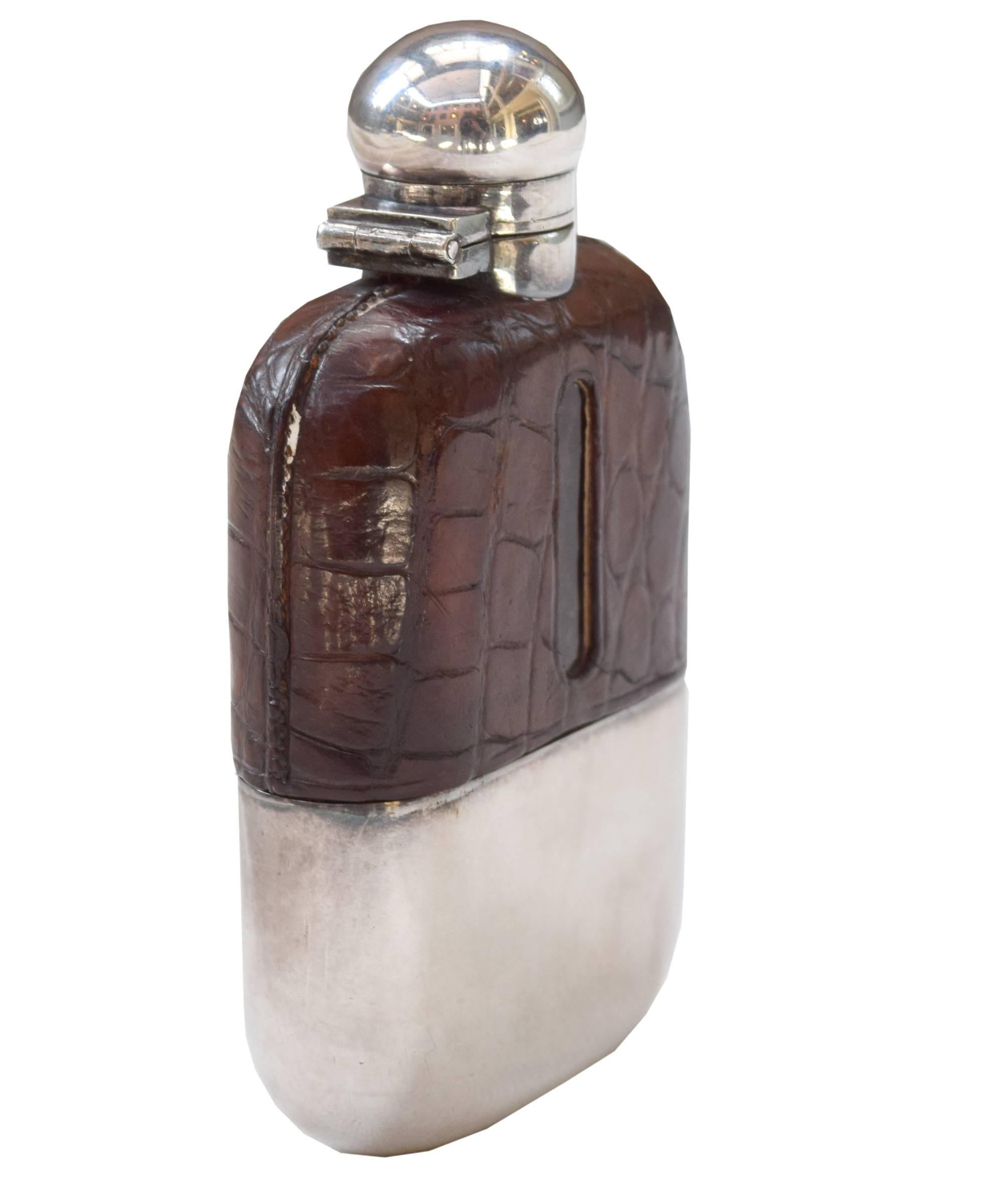 Petite ladies flask from London. This circa 1930 flask is covered in stamped leather and includes a removable silver plated drinking cup and bayonet style CAP. Originally sold by Drew and Sons, Picadilly circus.