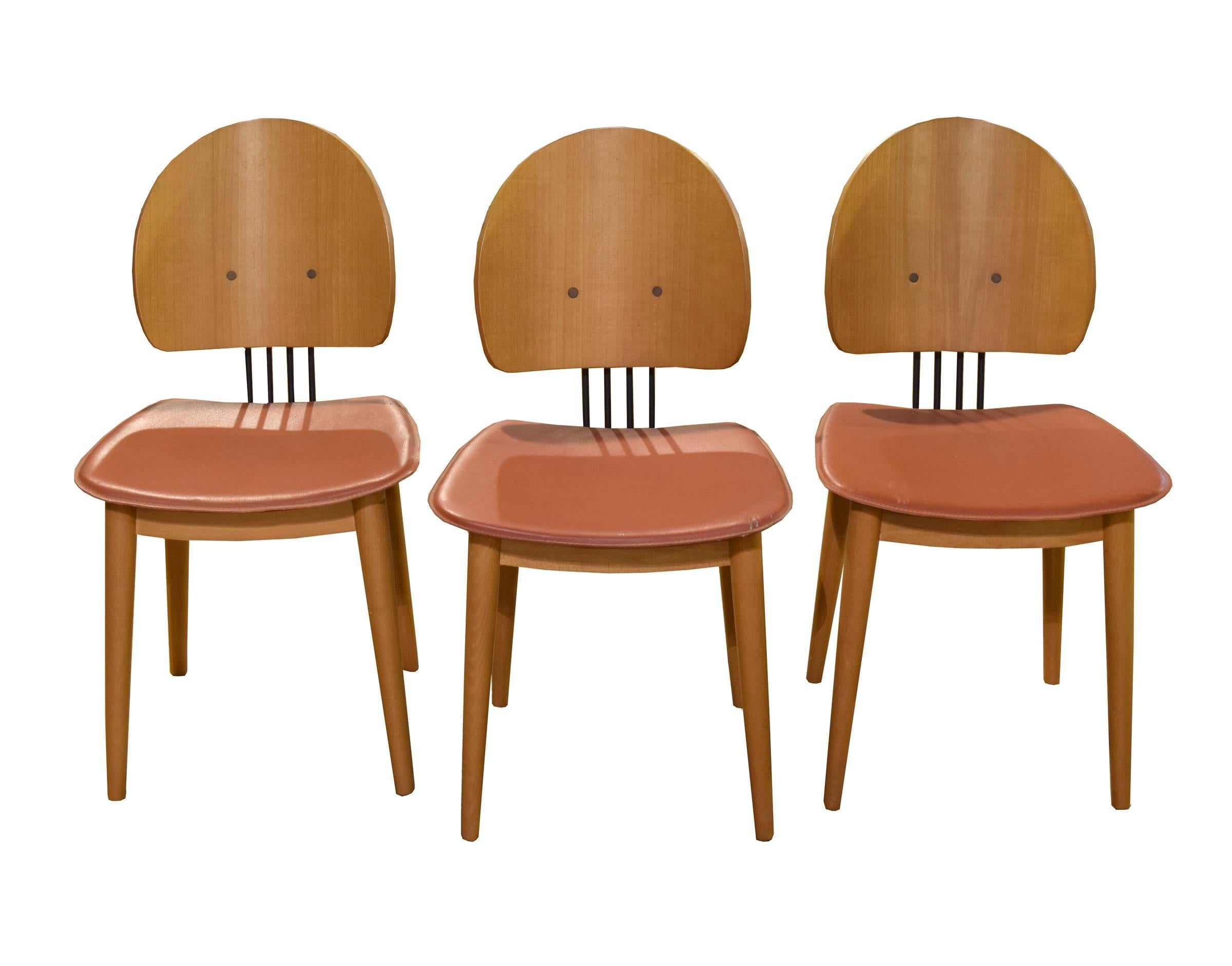 A set of six Mid-Century Modern chairs from Italy. These Mid-Century Modern chairs are made of bentwood with metal supports and mauve faux leather seats.