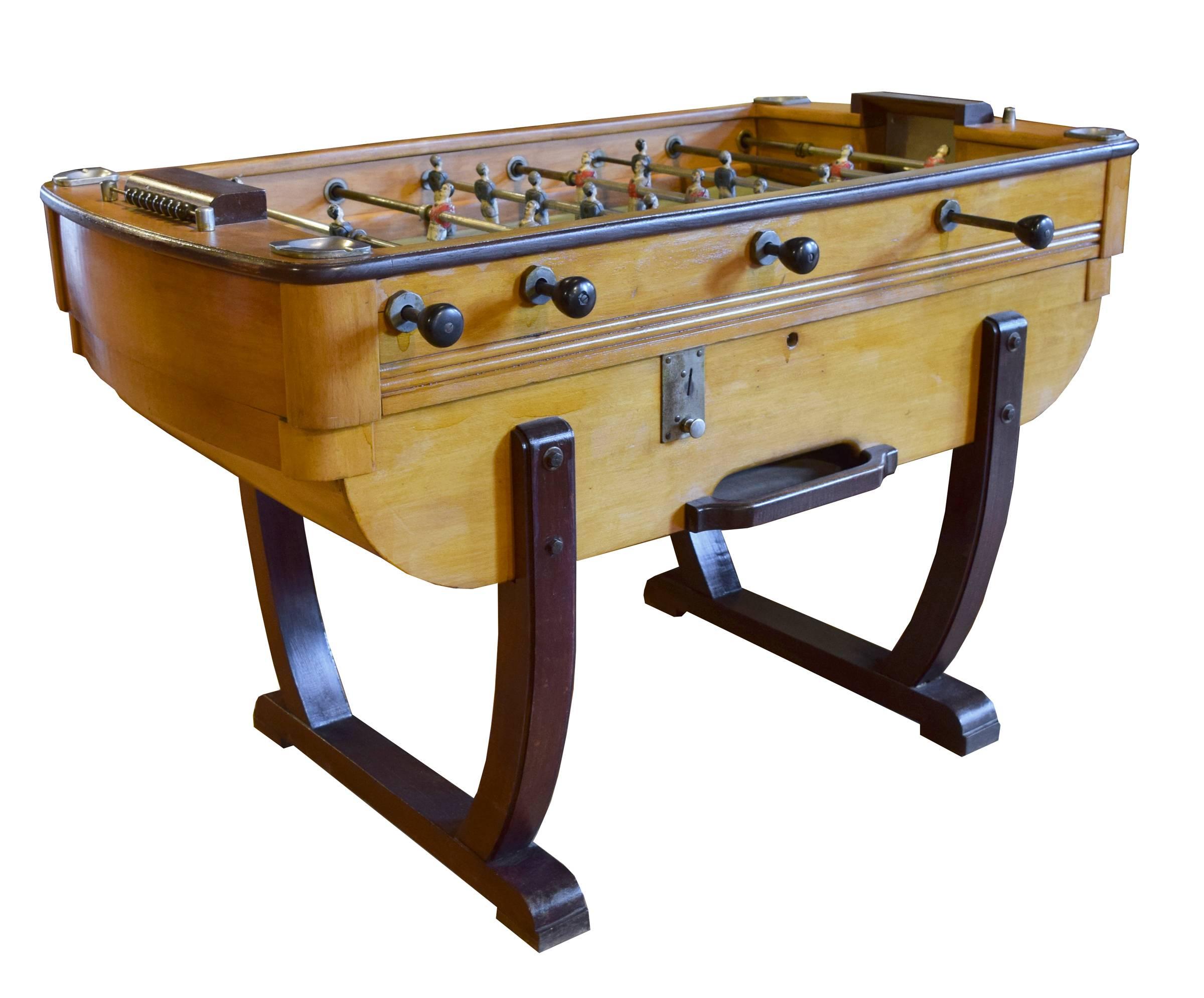 An Italian foosball table, circa 1930. The coin operated table features painted blue and red metal players on metal rods. The table also boasts dual manual scoring systems and four ashtrays.