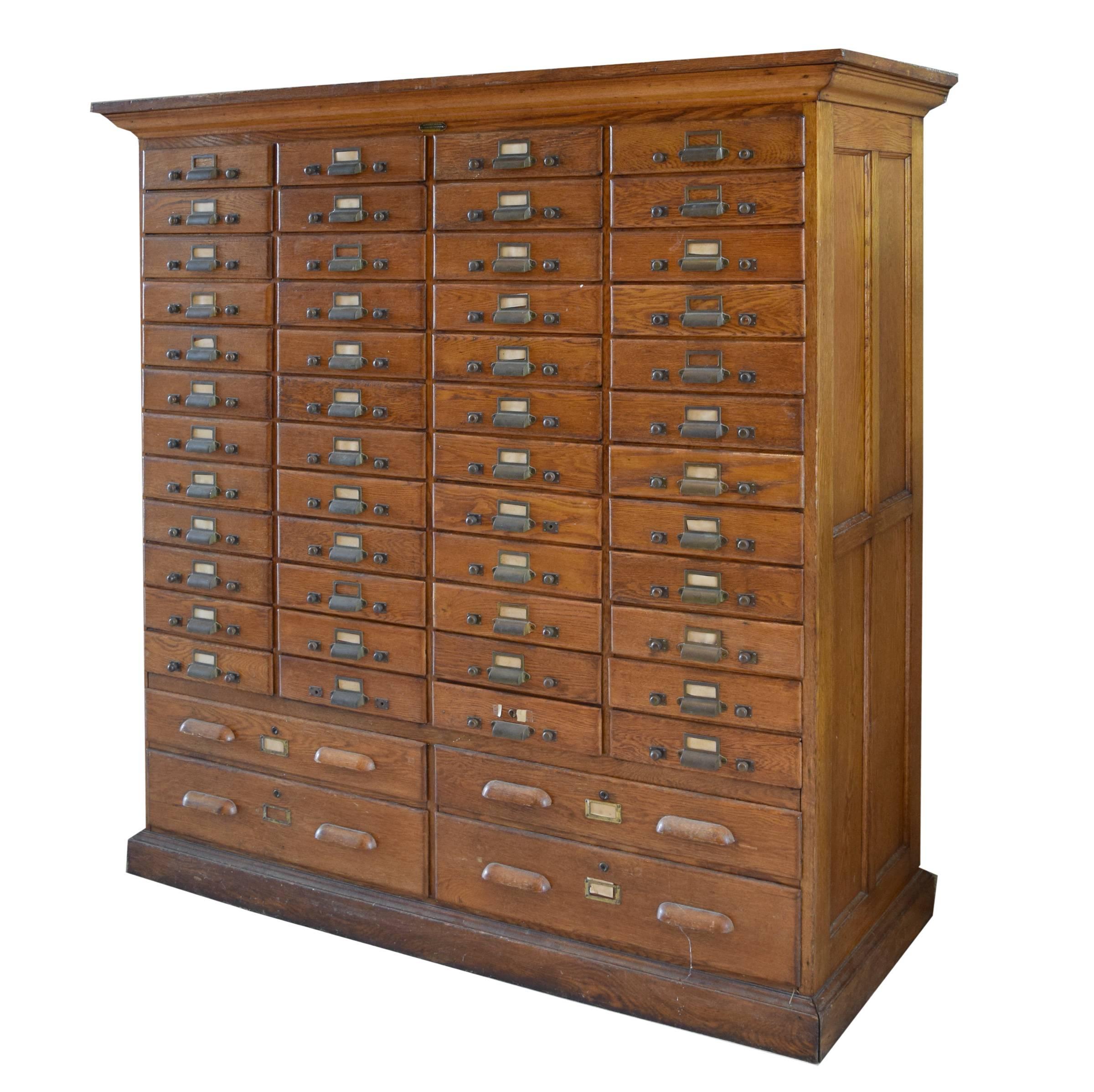 A 52-drawer card catalog. This oak piece was made by the Kewaunee Manufacturing Co of Kewaunee, Wi. Its many functional drawers makes it a great multi-use cabinet.
 