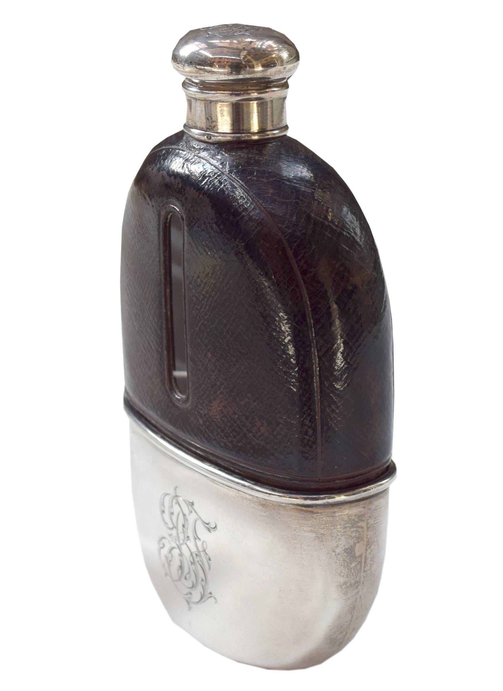 A sterling silver and leather flask from 1812 by Thomas Jenkins of London with a monogrammed gold lined cup and screw top cap.