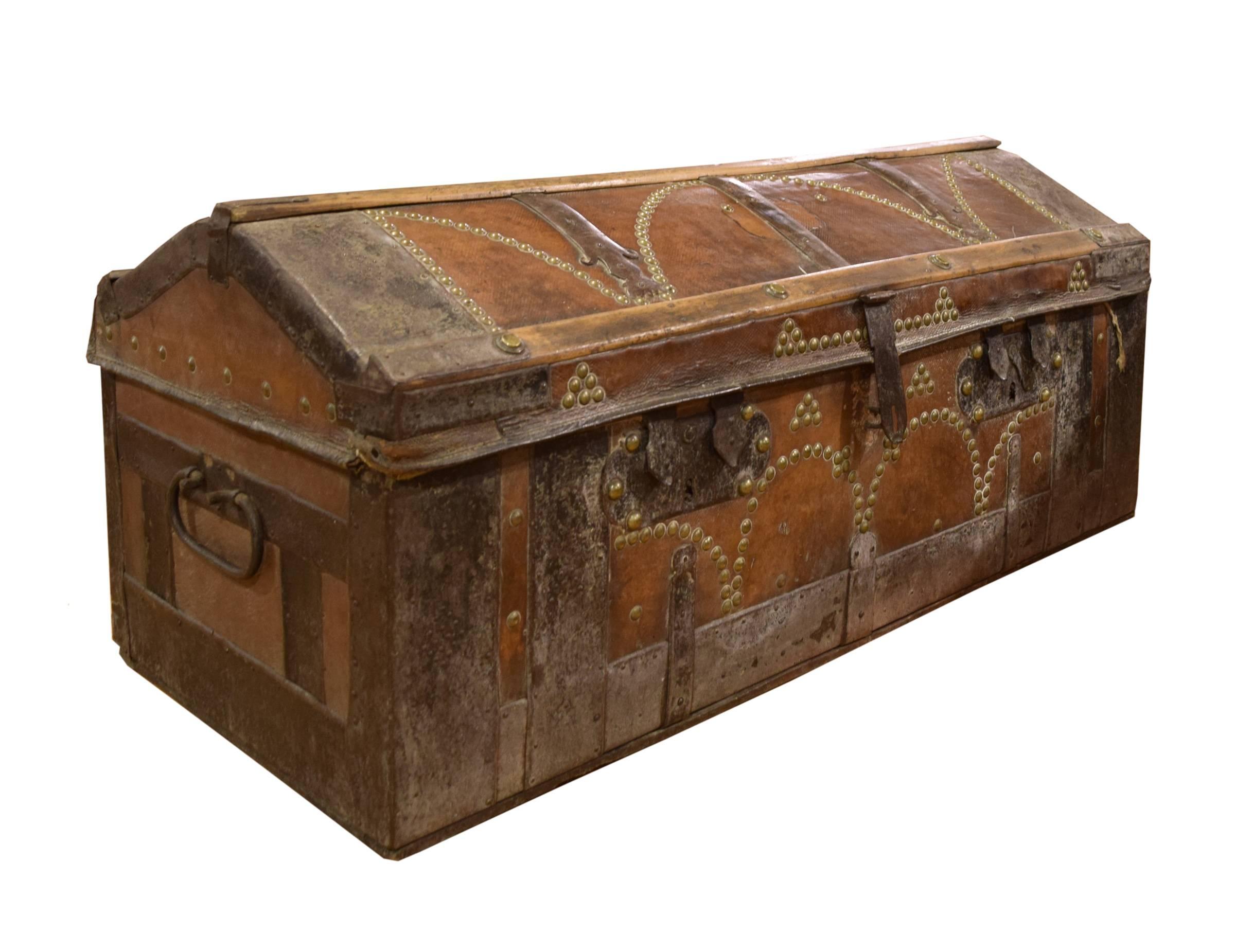 A fabulous 19th century wood and leather trunk. This Italian trunk has iron straps and brass stud detailing. The interior of the trunk is lined with canvas.