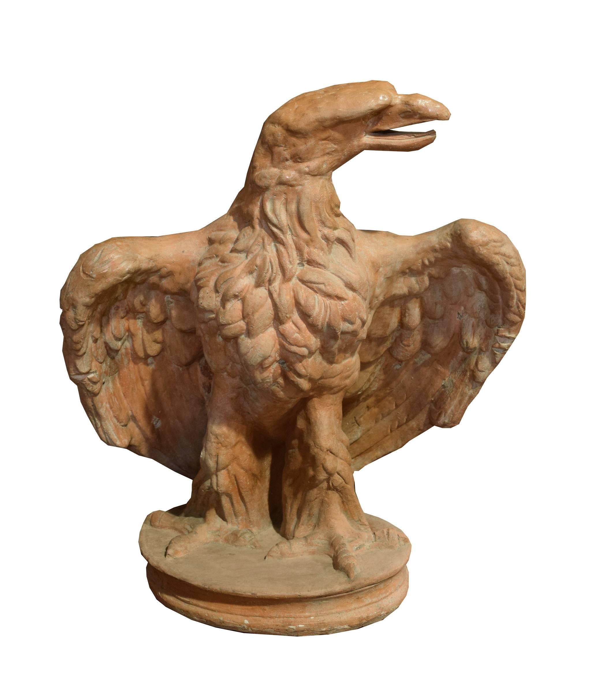 A majestic pair of circa 1880 life-sized terra cotta eagles from Italy.