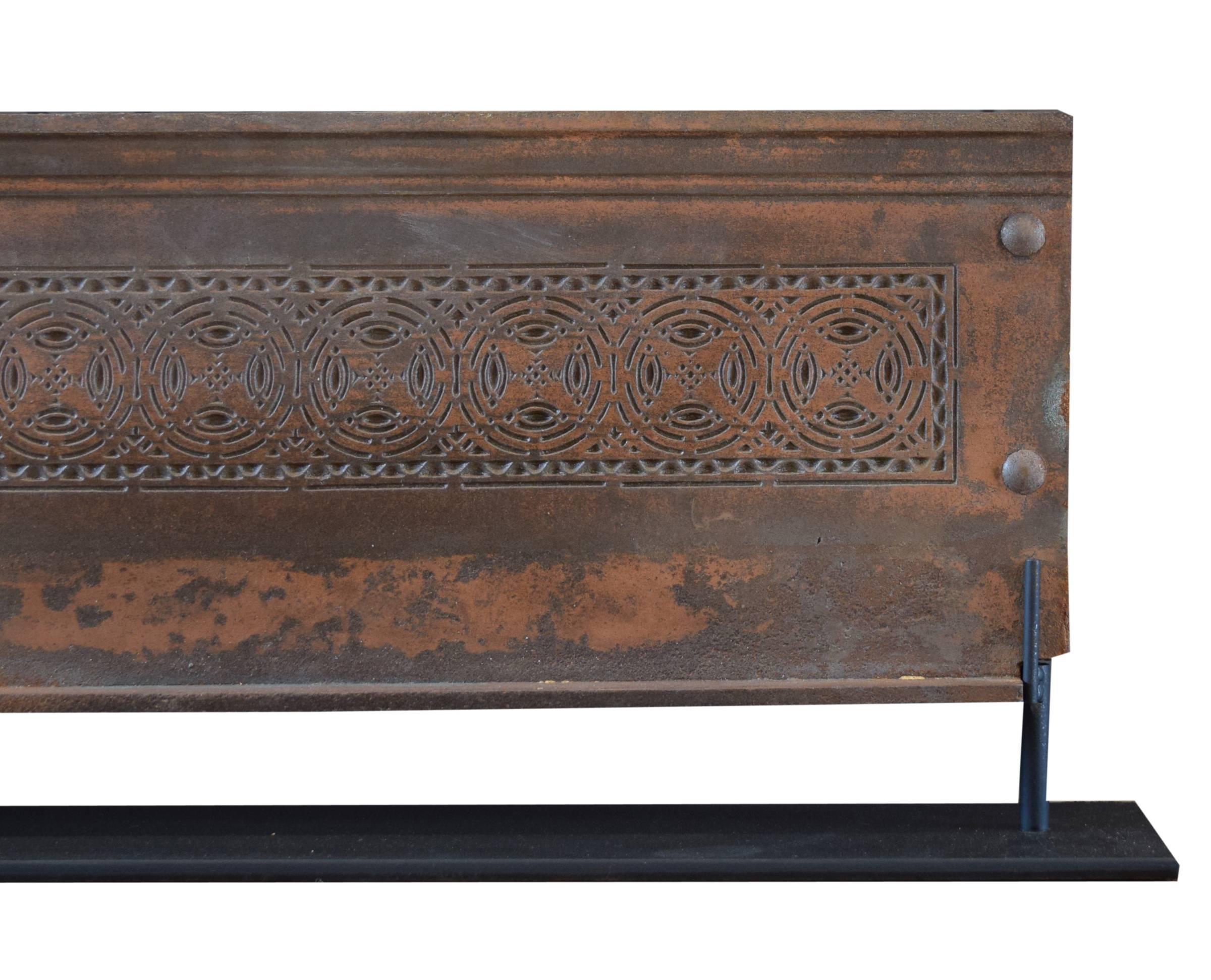 A copper over iron stair riser from the Chicago Stock Exchange by Adler and Sullivan, 1983-1984. This intricate piece was designed by Sullivan and fabricated by the Winslow Brothers Foundry in Chicago. It sits on a custom steel mount.