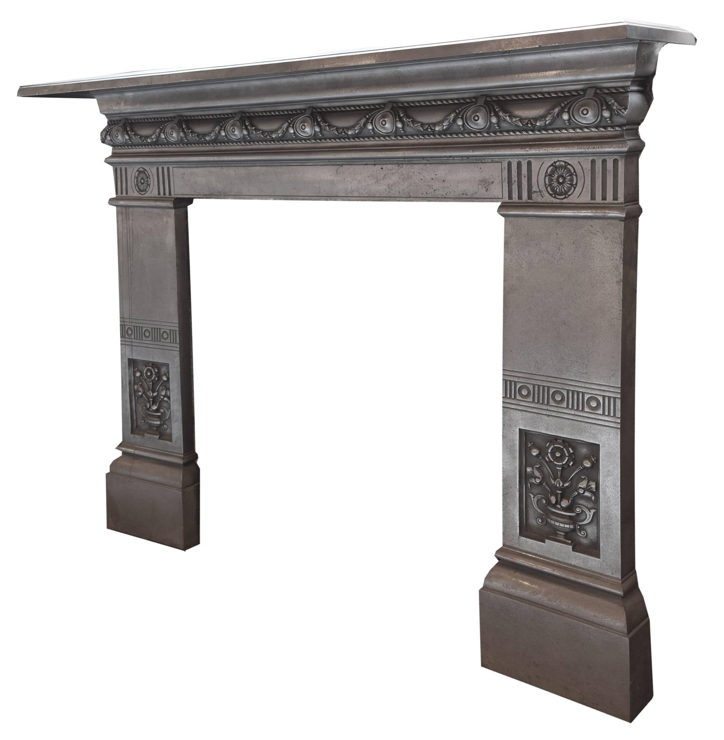 A late 19th century English cast iron fireplace surround with floral swags across the apron and potted flowers on each leg.

Interior dimensions:
35.5