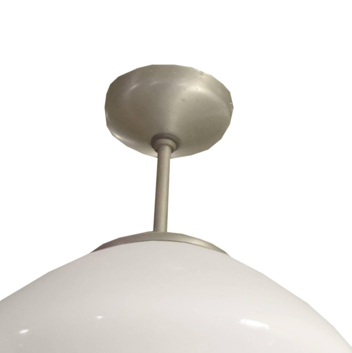A Mid-Century American beehive form pendant light with an opaque glass shade suspended from a brushed metal down-rod and canopy. Several Available.
Need to be re-wired.

 