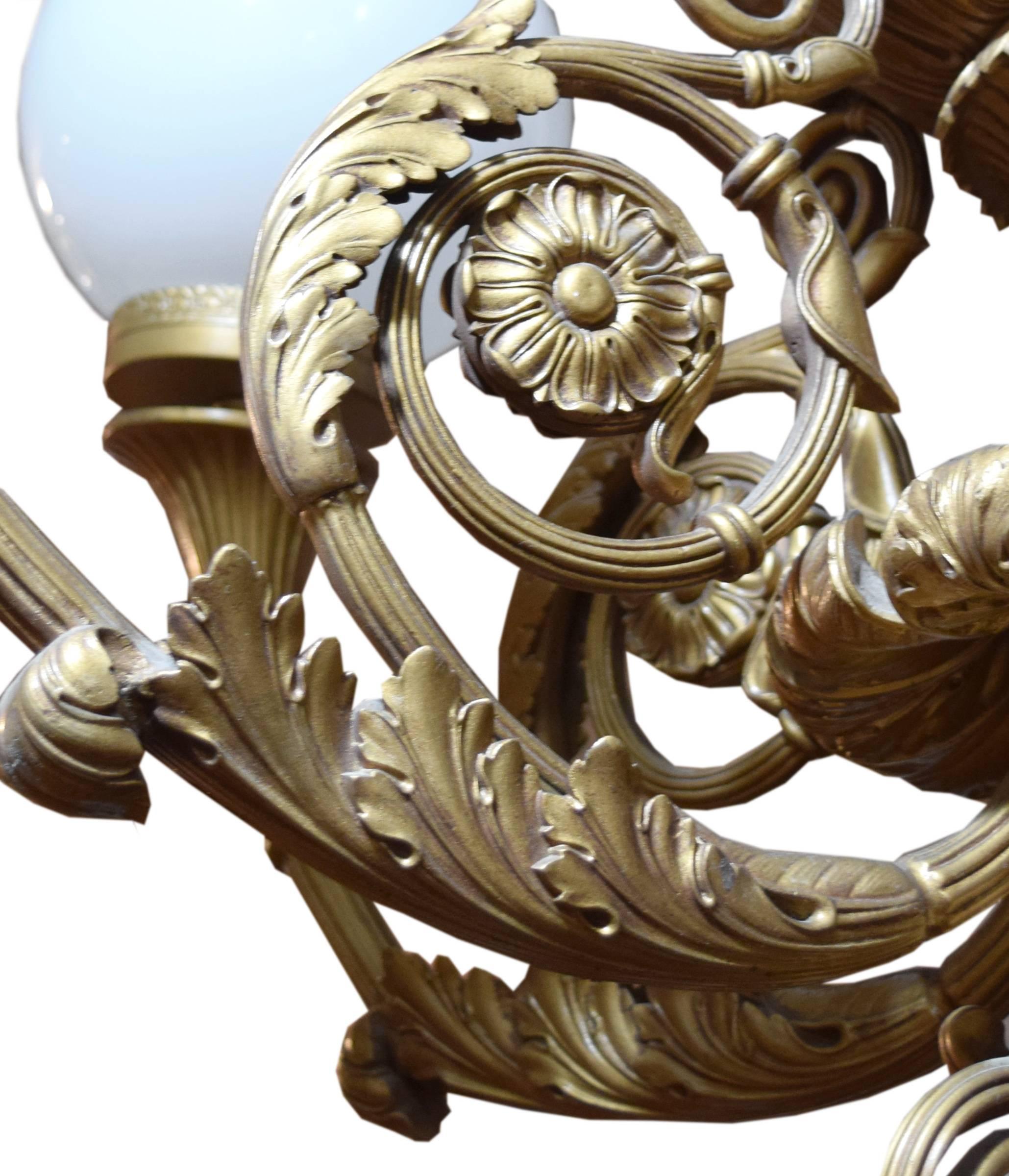 An American chandelier from the Marbro Theater, Chicago, Illinois having nine arms with glass shades, and scrolling acanthus leaf and floral motif. This chandelier hung in Chicago’s Water Tower visitor’s center after the Marbro Theater was razed in