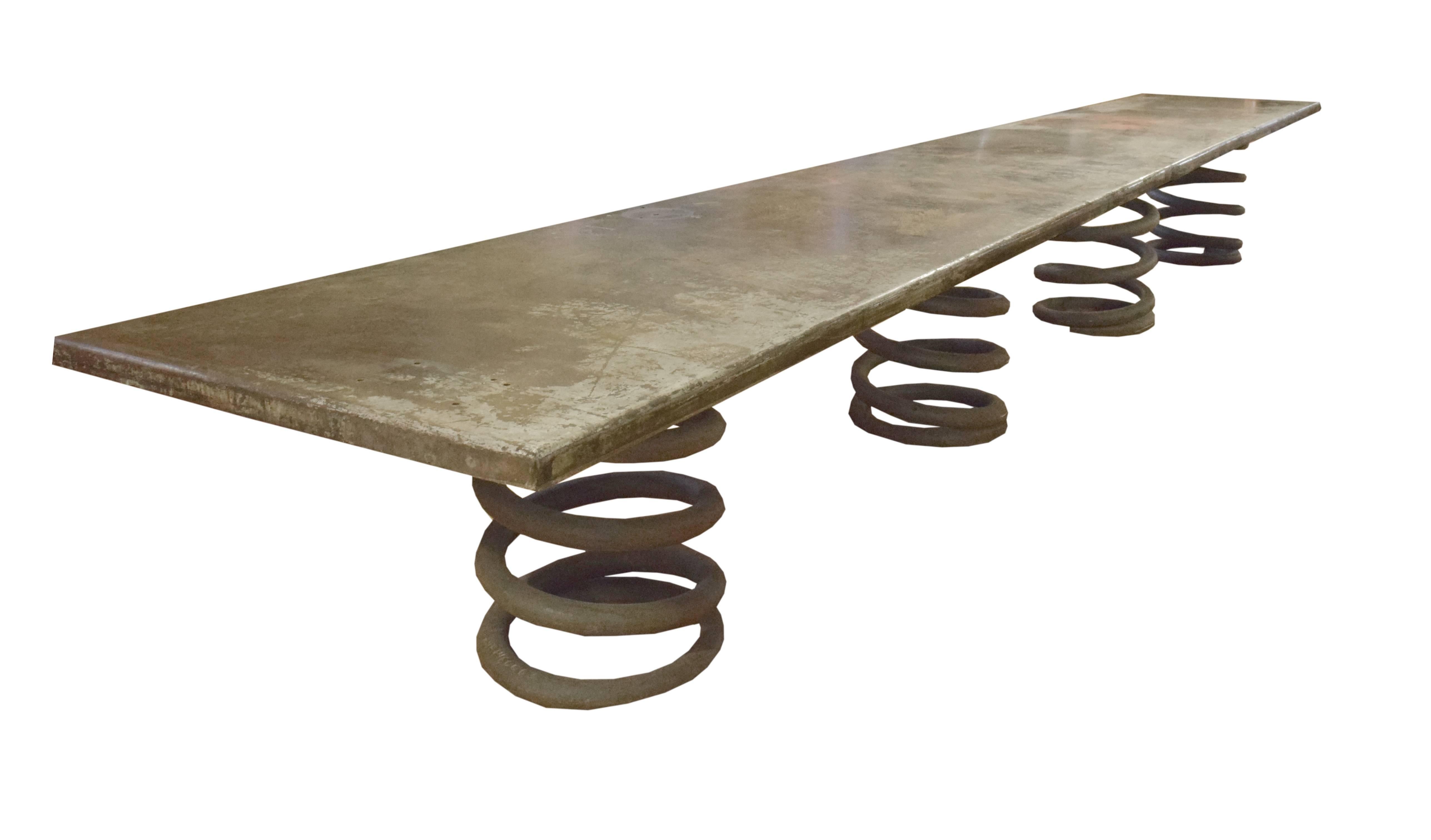 A massive 20-foot table constructed with a metal top with great patina from the auto shop at New Trier High School in Winnetka, Illinois, and four heavy-duty Industrial spring legs.
