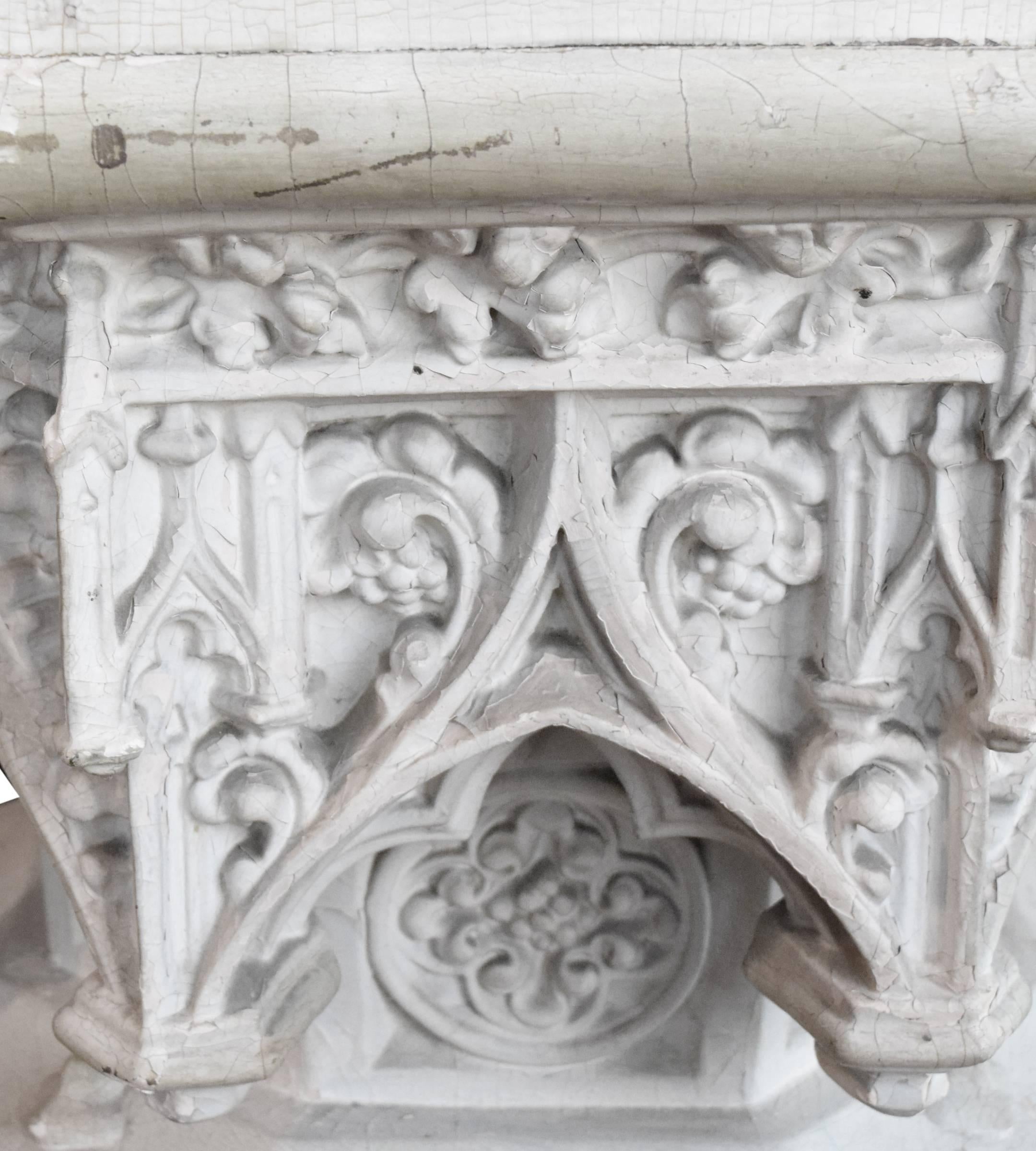 An early 20th century American Gothic carved wood pedestal, from the DePaul University Museum.