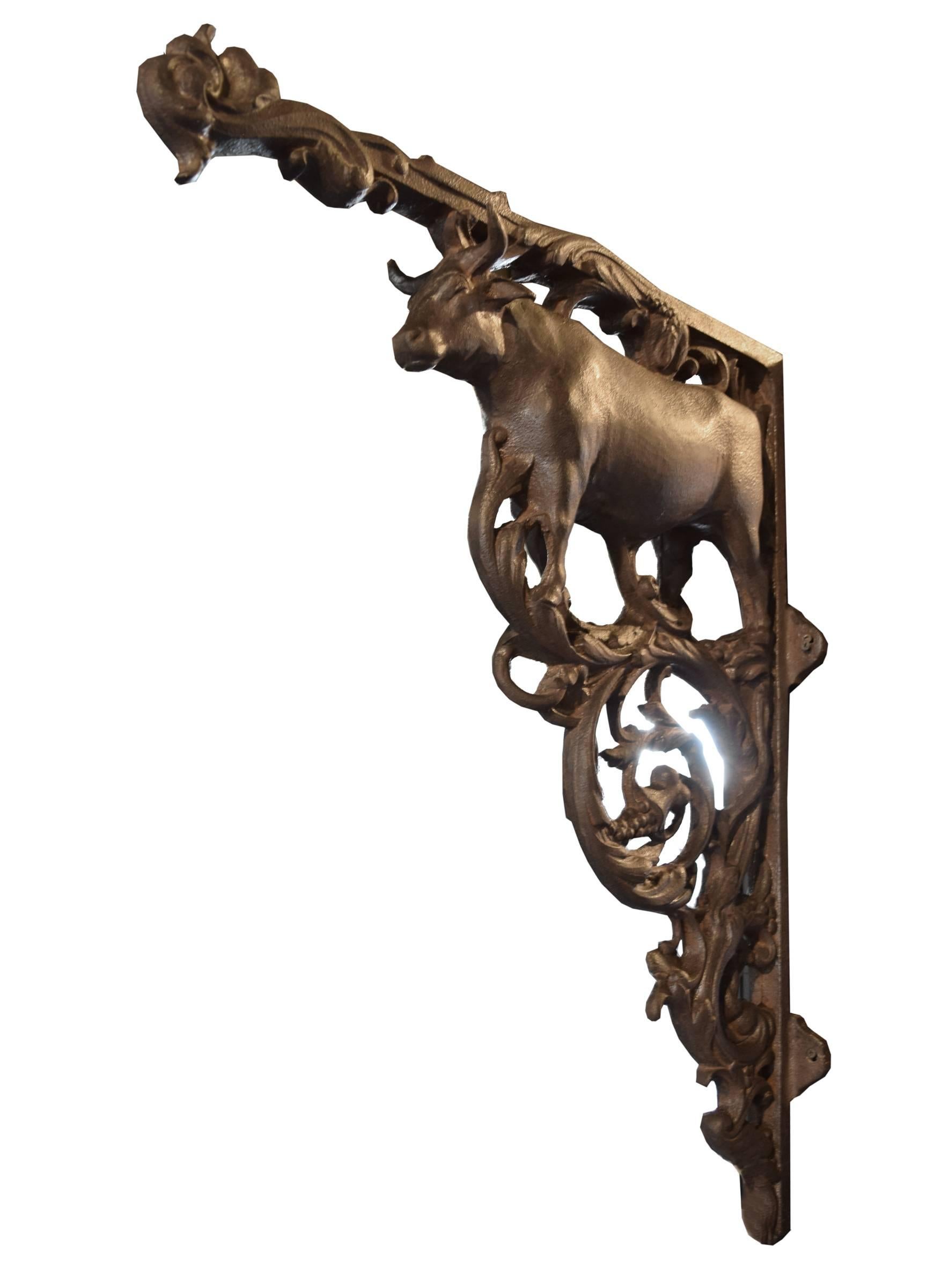 Incredible French cast iron butcher shop sign bracket with wonderfully cast bull and scrolling vines, 19th century.