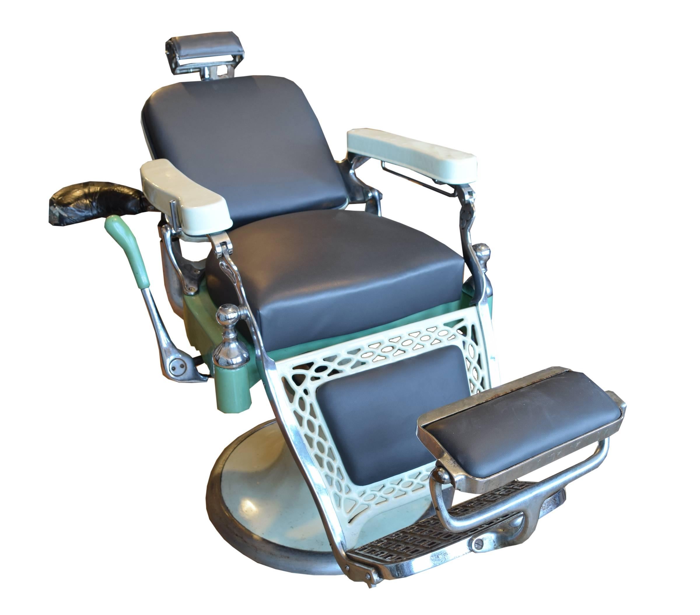 An Emil J Paidar Company, Chicago, Illinois, duo-hydraulic barber shop chair with upholstered seat, headrest, and footrest, and porcelain enameled armrests and leg rest, with rare attached barber's seat, circa 1920.