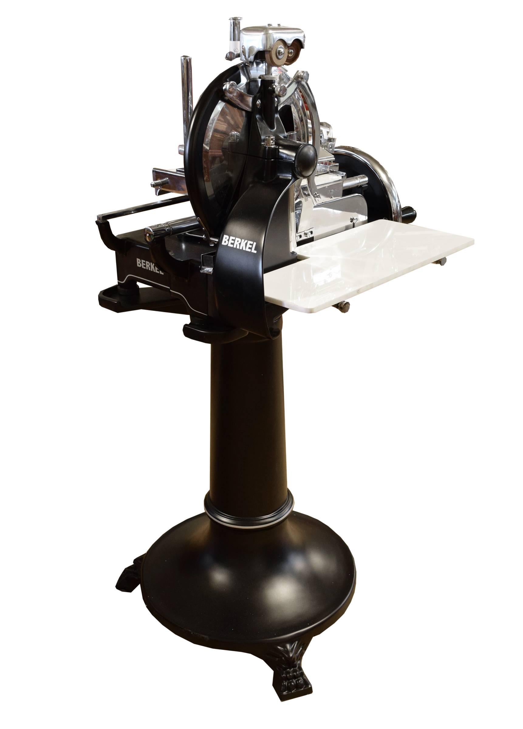 A rare Berkel model P prosciutto slicing machine in a matte black enamel, manufactured in Milan, Italy. This model, made from 1932-1945 is flywheel operated and features eight different slicing thicknesses and a blade sharpener. At the time of its