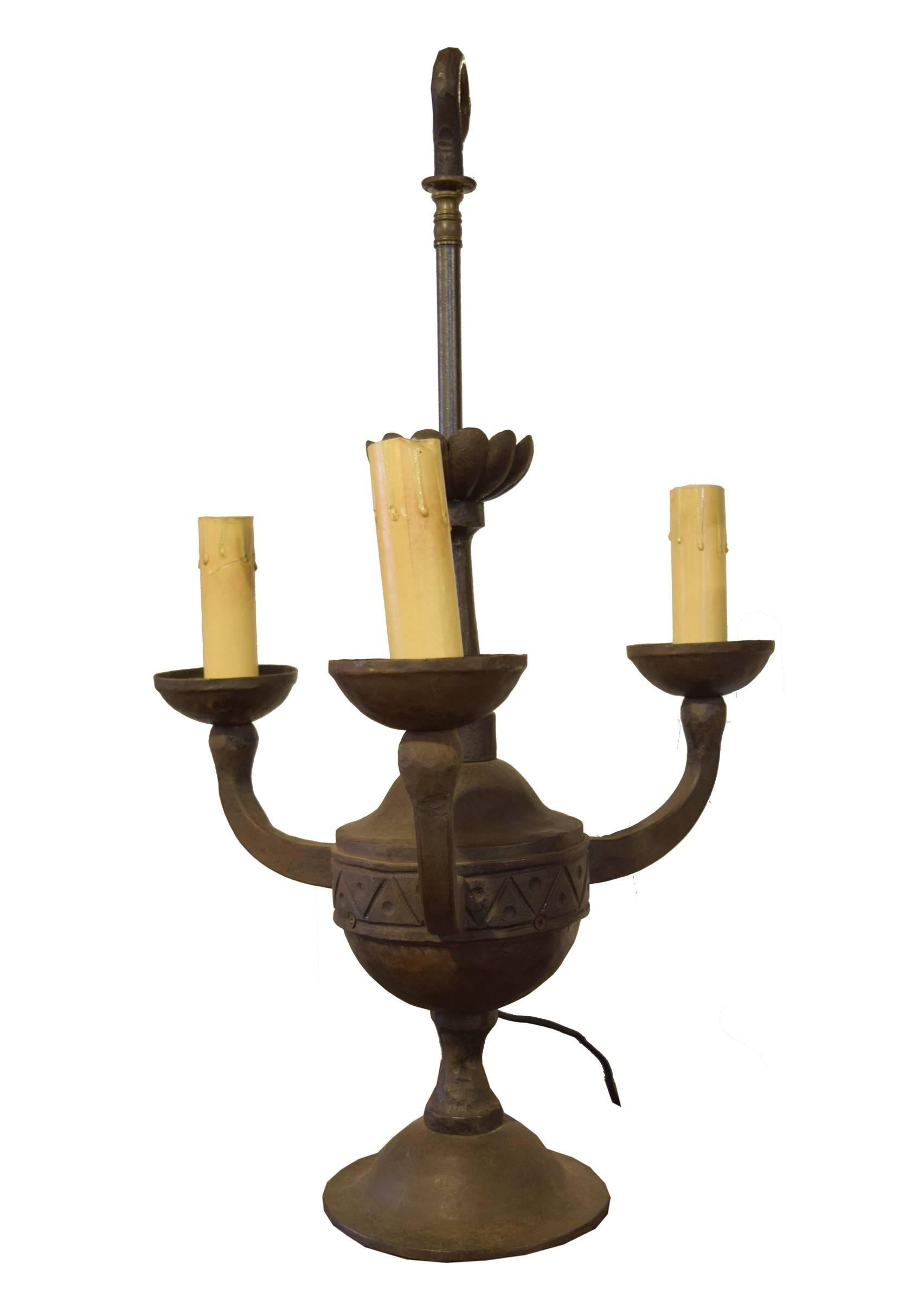 Argentine wrought iron three-arm fixture by famed blacksmith, Jose Thenee. With its shepherd’s crook top and flat bottom, this light fixture can be hung or used as a table lamp. Thenee is considered one of the world's greatest blacksmiths and won