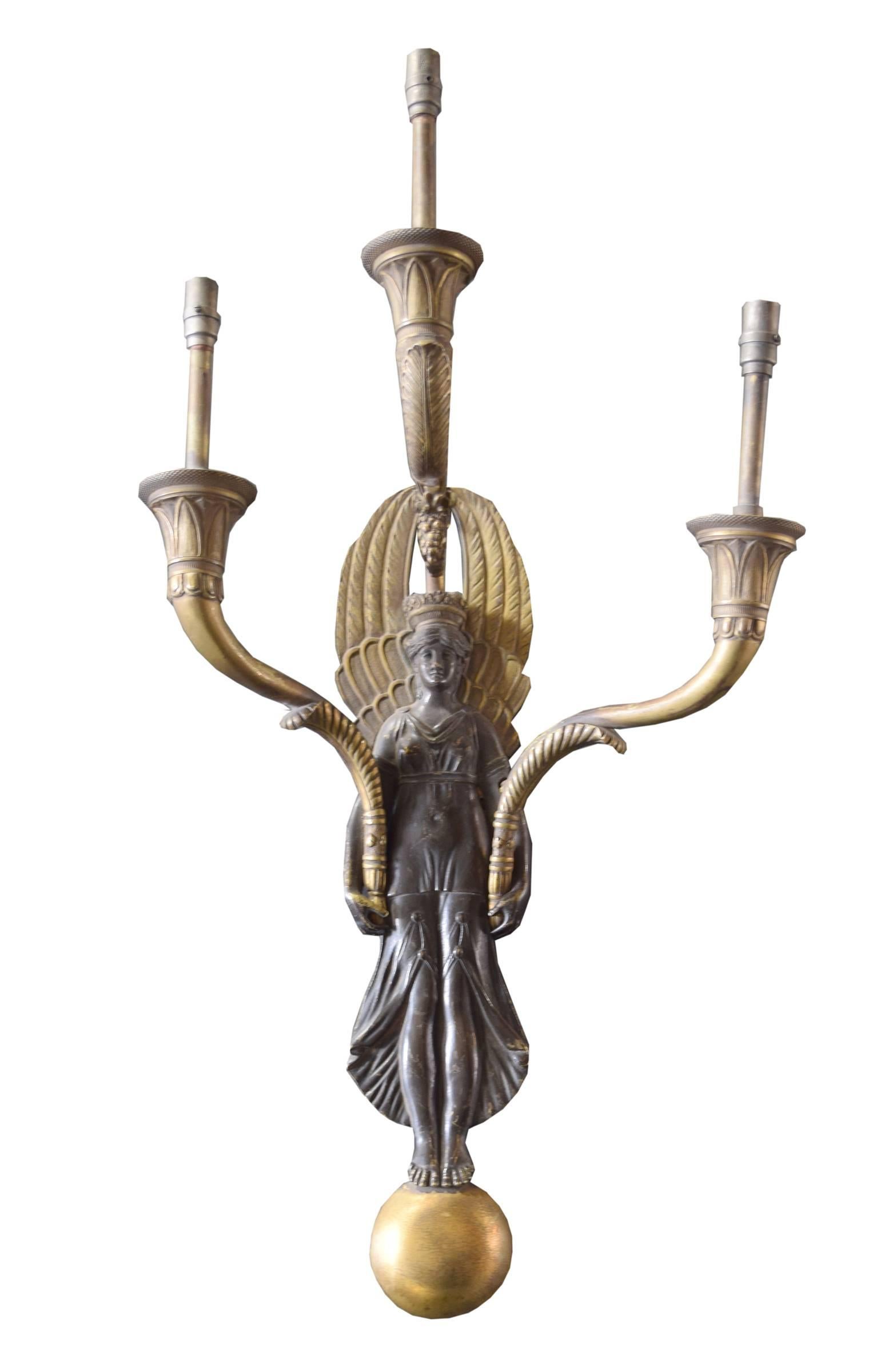 Pair of American bronze three-arm wall sconces with neoclassical winged maidens standing atop golden orbs. 

In original condition, fitted for gas. Need to be wired.