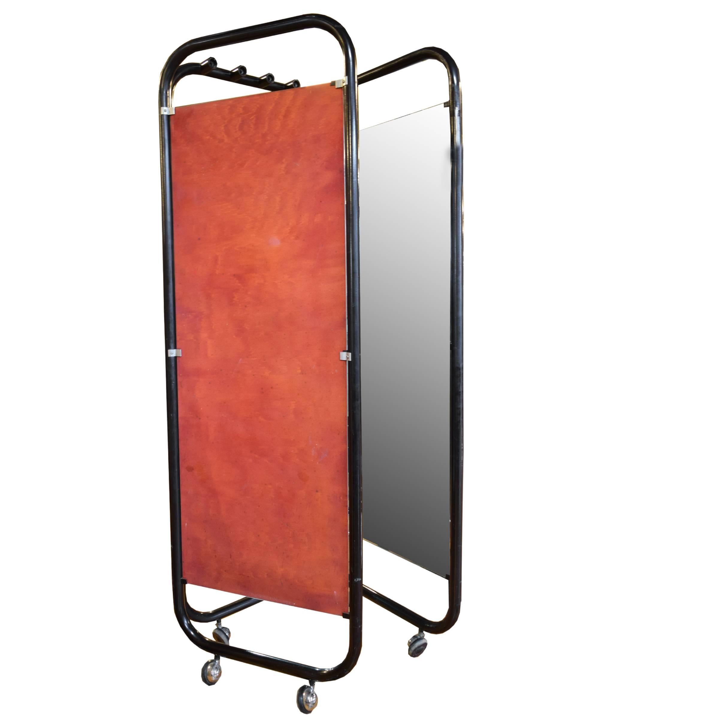 A funky Mid-Century Italian three-panel folding dressing mirror, with four lights in the center, tubular steel frame and casters. Lots of personality!

Wired for Europe.