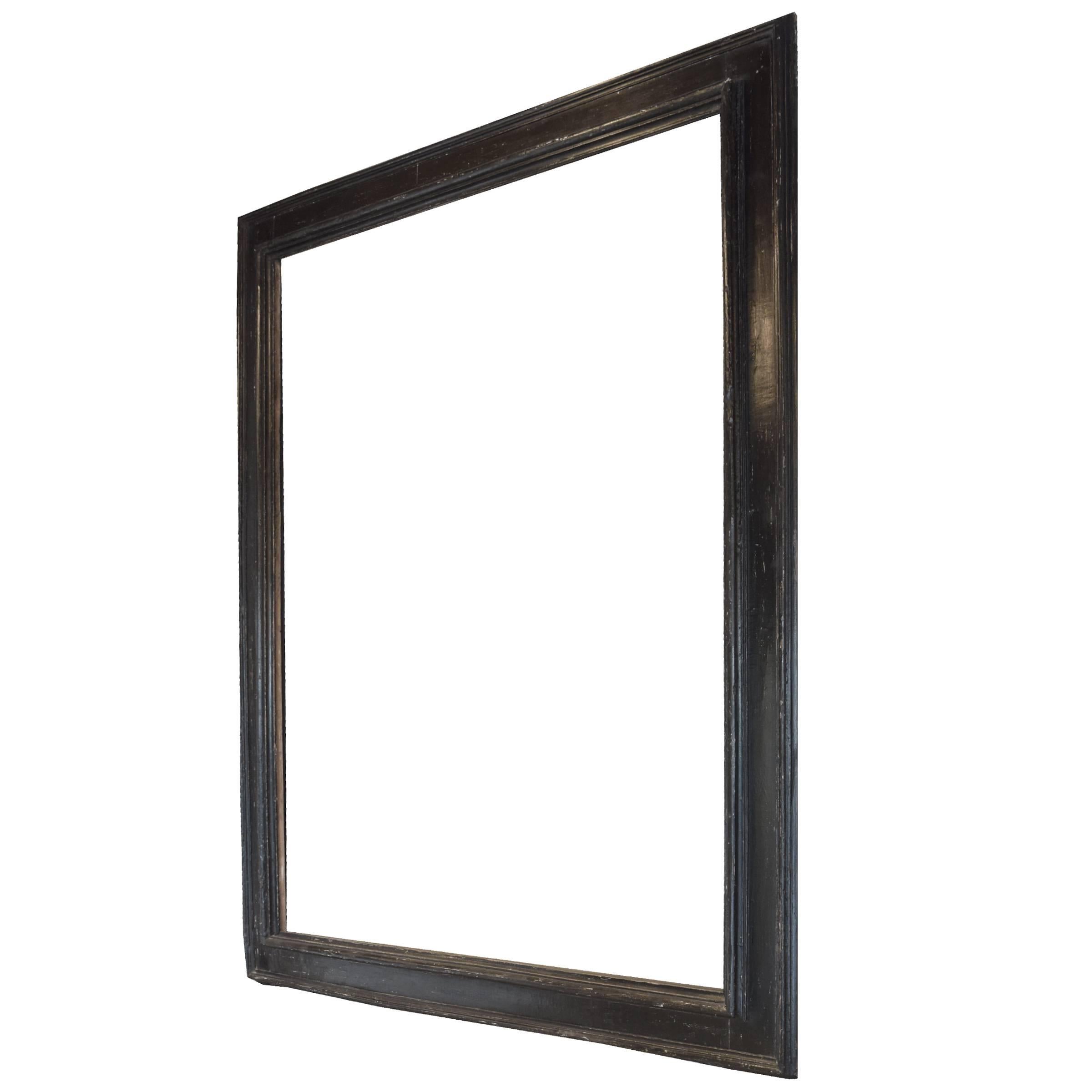 A monumental 18th century northern Italian ebonized frame of wonderful proportion, with original wrought iron hangers.