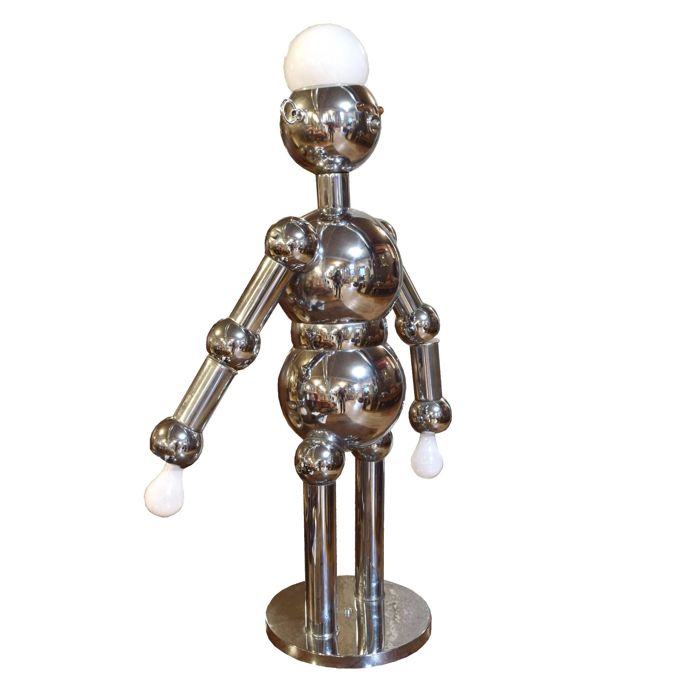 A very fun chrome robot lamp by Torino Lamp Company of Italy. Standing just over 3 feet tall, this is the largest model in their robot lamp series and features a large bulb in the head and articulated arms with bulbs in each hand, circa 1960s.
  