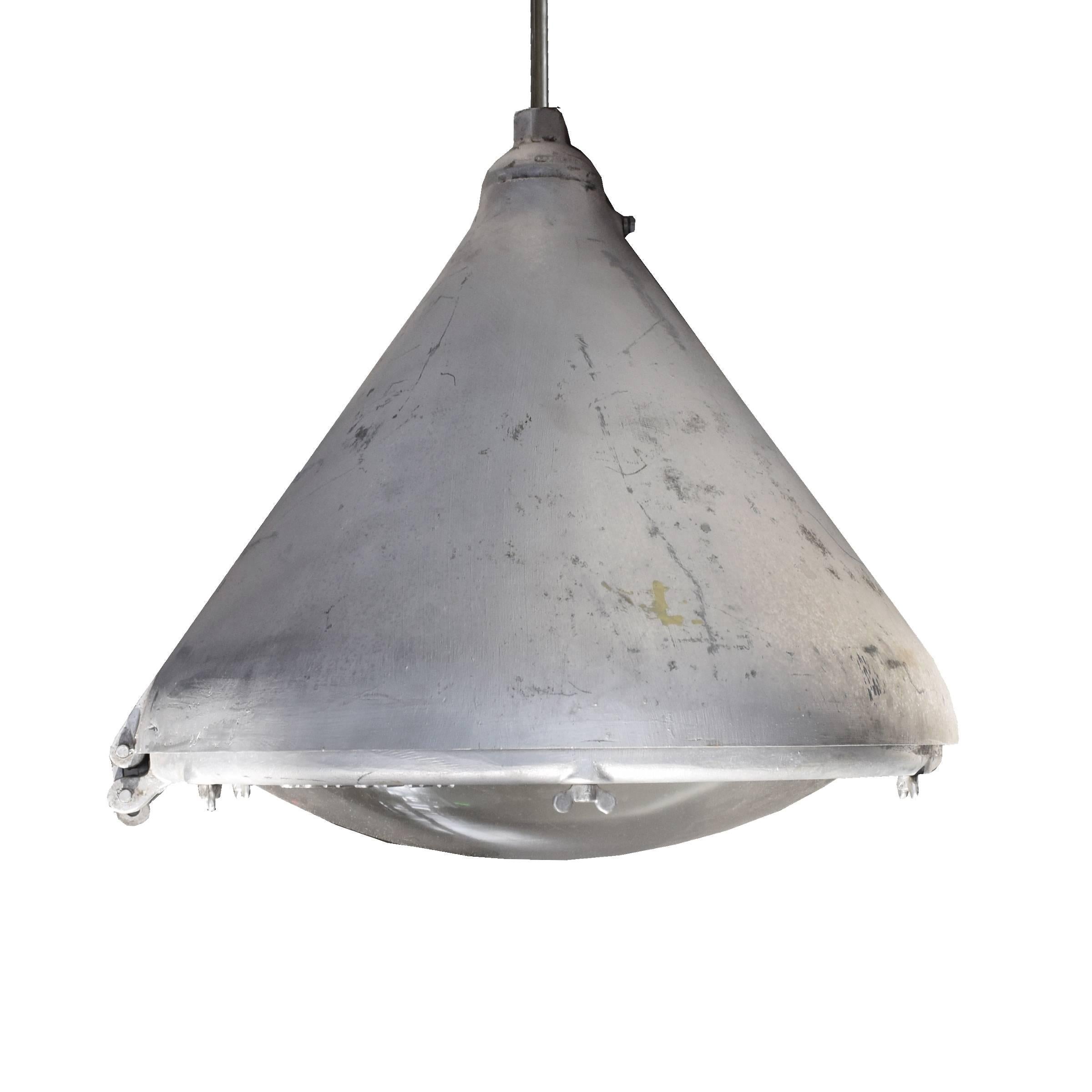 An American Industrial light fixture in an unusual form with Pyrex 'dust tight' glass shades manufactured by the Appleton Electric Company of Wisconsin. Four available.