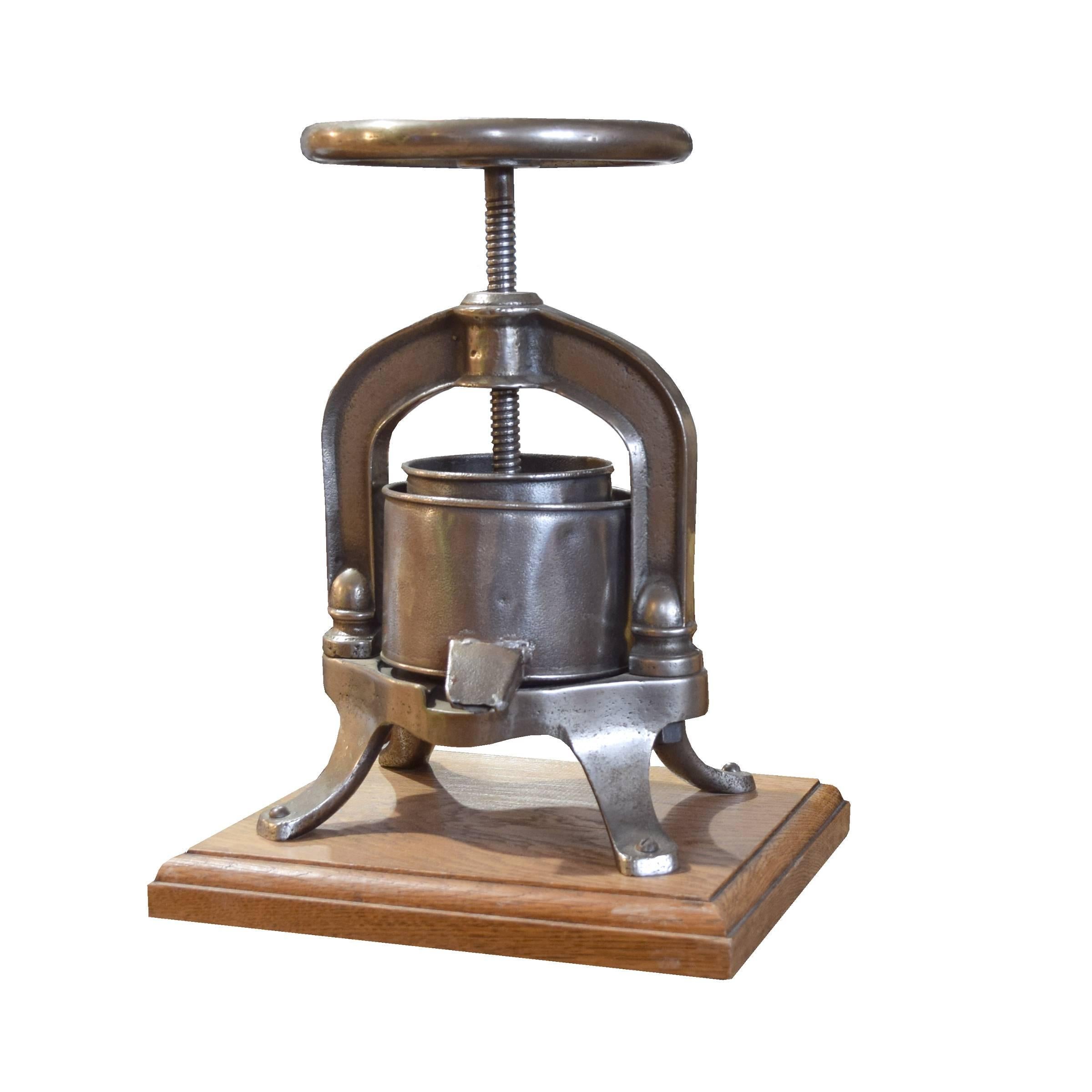 A fun French polished iron food press on a newer oak base, 19th century. Perfect for the foodie in your life!