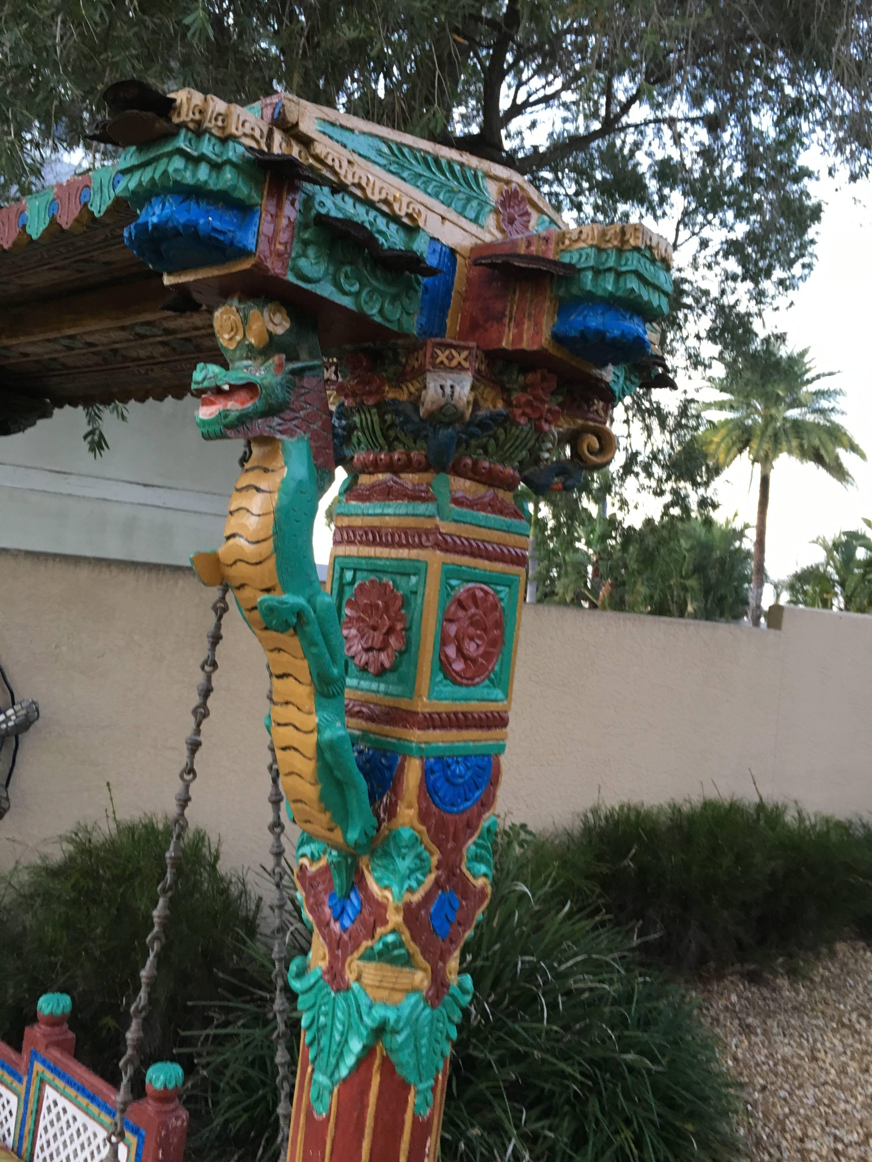 An Indian hand-carved, hand-painted teak royal jhula swing. Seats three. Very colorful and in wonderful condition for 500 years old.