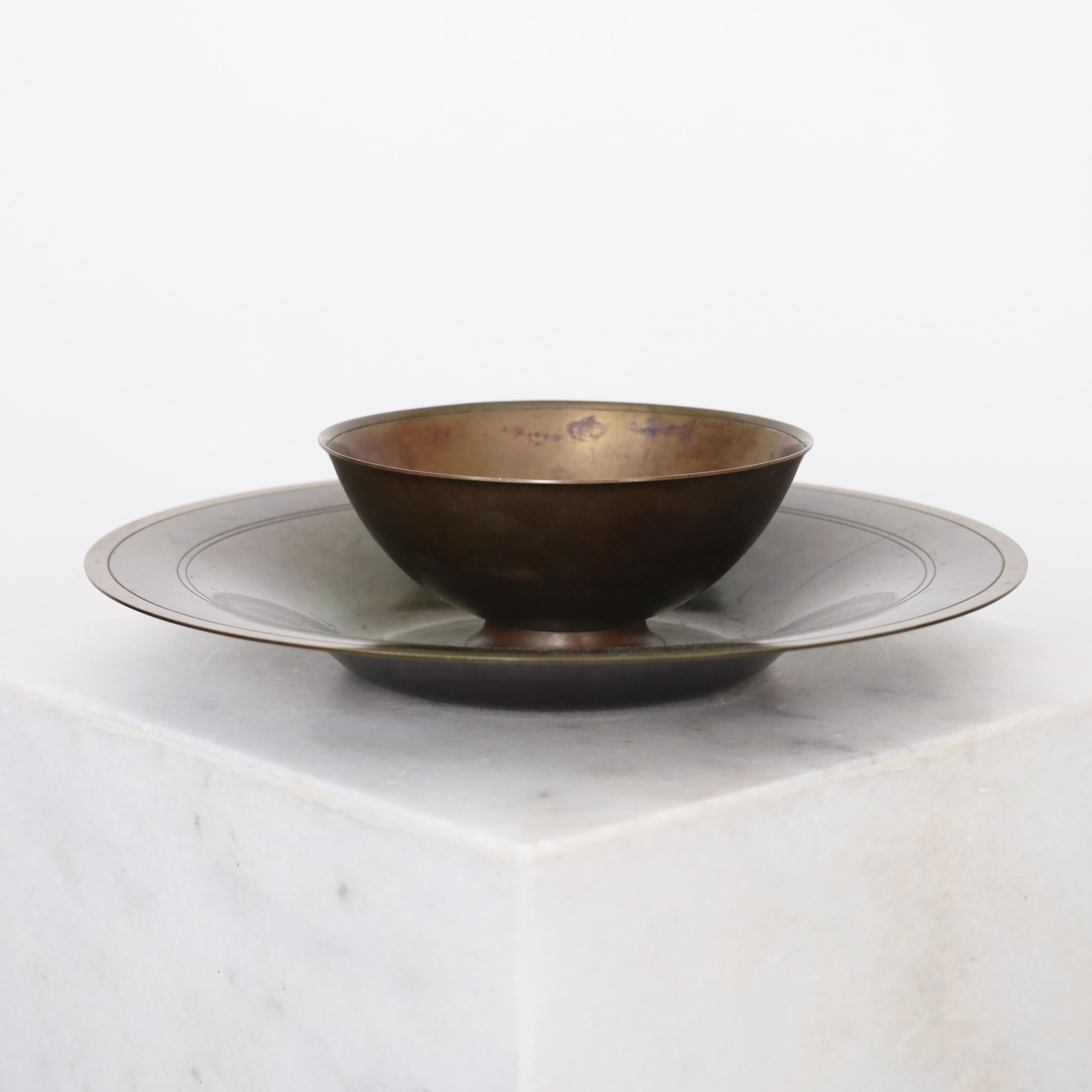 Set of plate and bowl designed by Just Andersen in the early 1930s. A fine set for a beautiful place.

* A plate and bowl on foot in light-bronze alloy
* Designer: Just Andersen
* Model: LB1387 &  LB1598 
* Year: 1930 & 1934
* Condition: Very good