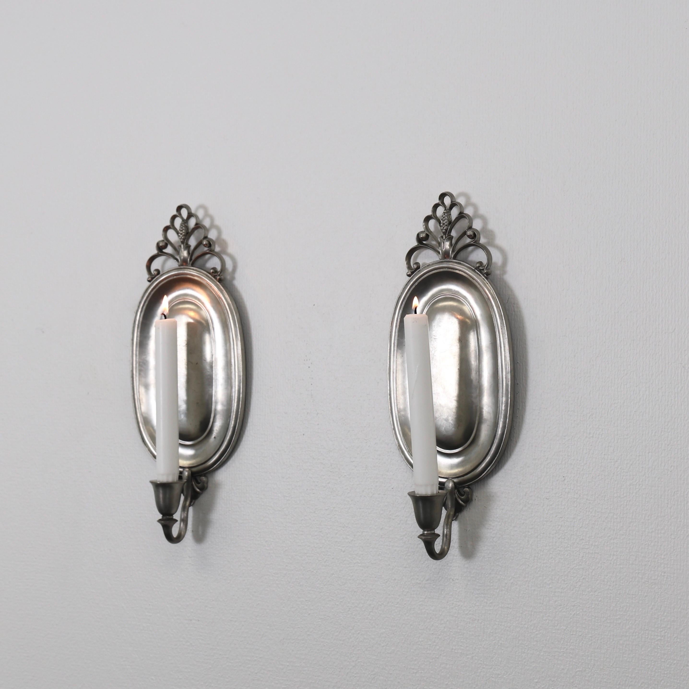 Set of Pewter Wall Candle Sconces designed by Just Andersen in 1920s. A rare, exquisite duo for beautiful place. 

* Pair (2) of pewter wall candlestick holders
* Designer: Just Andersen
* Manufacturer: Just Andersen
* Style: 1217
* Year: