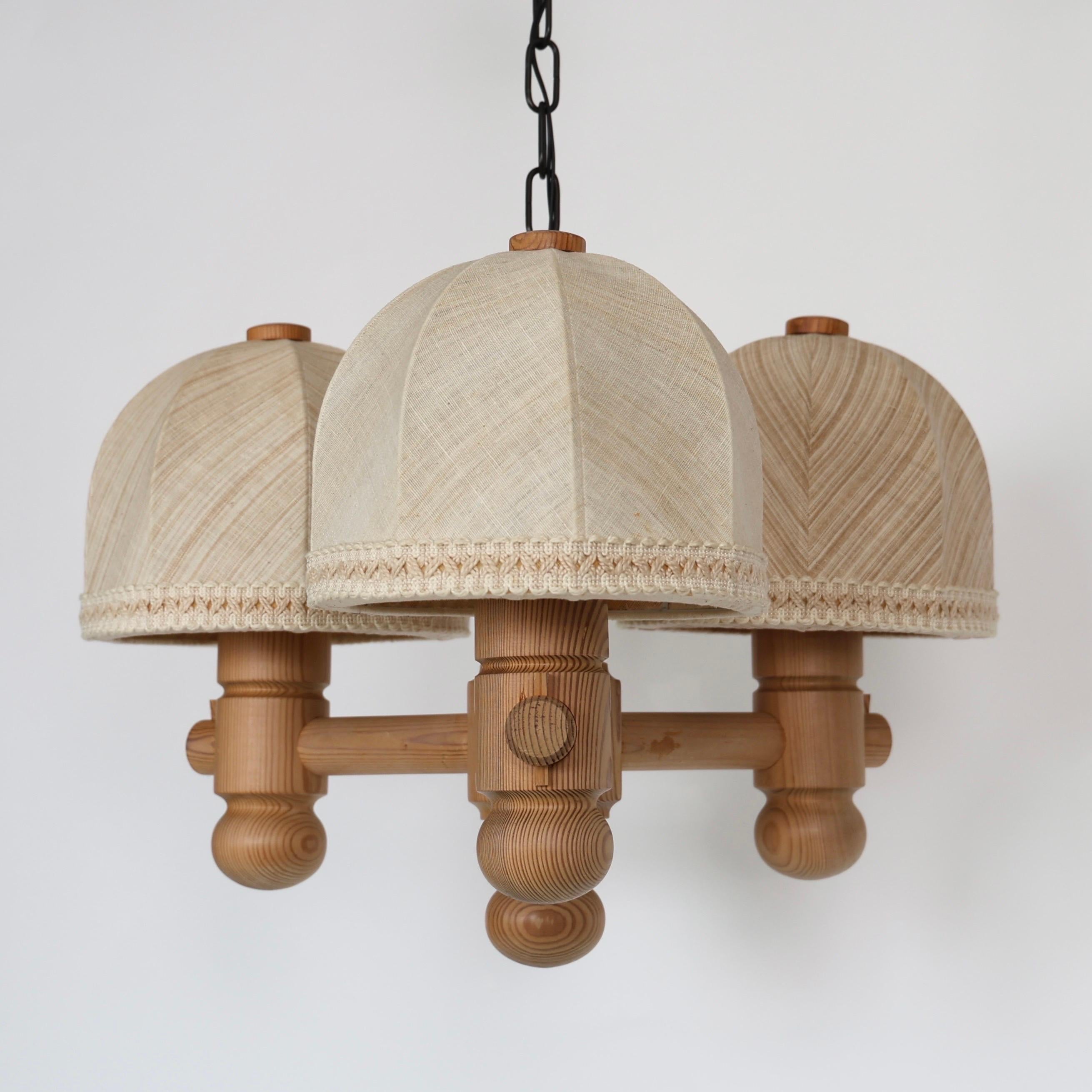 Light White Stained Pine Wood Chandelier with Original Shades designed by Jan Wickelgren for Aneta in the 1970s. A cosy piece of lightning for an exquisite home.   

* Light-white stained pine wood pendant light with three fabric shades and chain