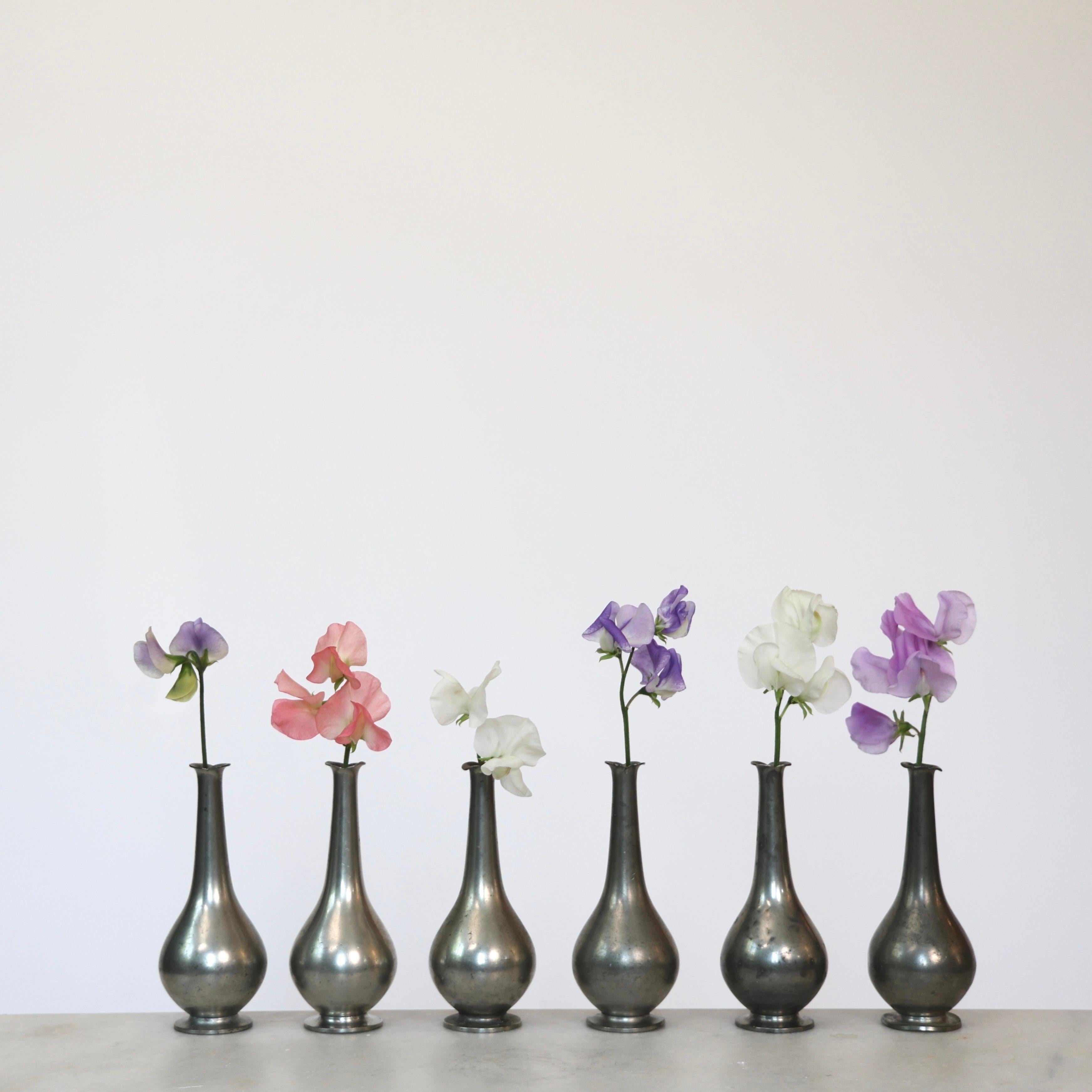 Collection of Six Pewter Vases made by Just Andersen in the 1920s. 

* Set (6) of round pewter vases with slim necks 
* Designer: Just Andersen
* Manufacturer: Just Andersen
* Style: 1457
* Year: 1918-1926
* Condition: Fair vintage condition. Makers