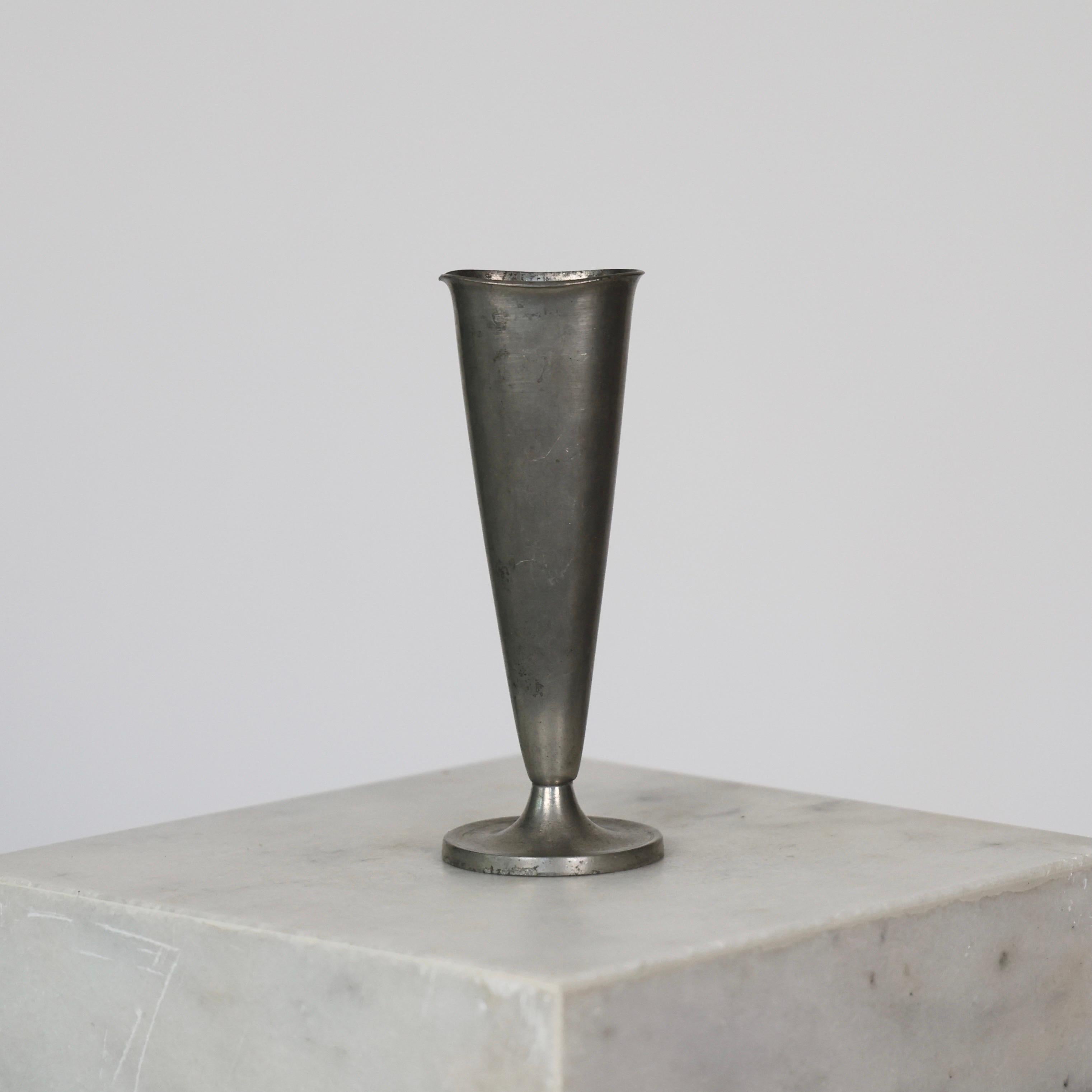 Elegant Conical Pewter Vase made by Just Andersen in the 1950s. 

* Conical pewter vase on foot
* Manufacturer: Just Andersen
* Style: 2573
* Year: 1952
* Condition: Good condition. Makers engraving intact. Marks and surface scratches. A small dent