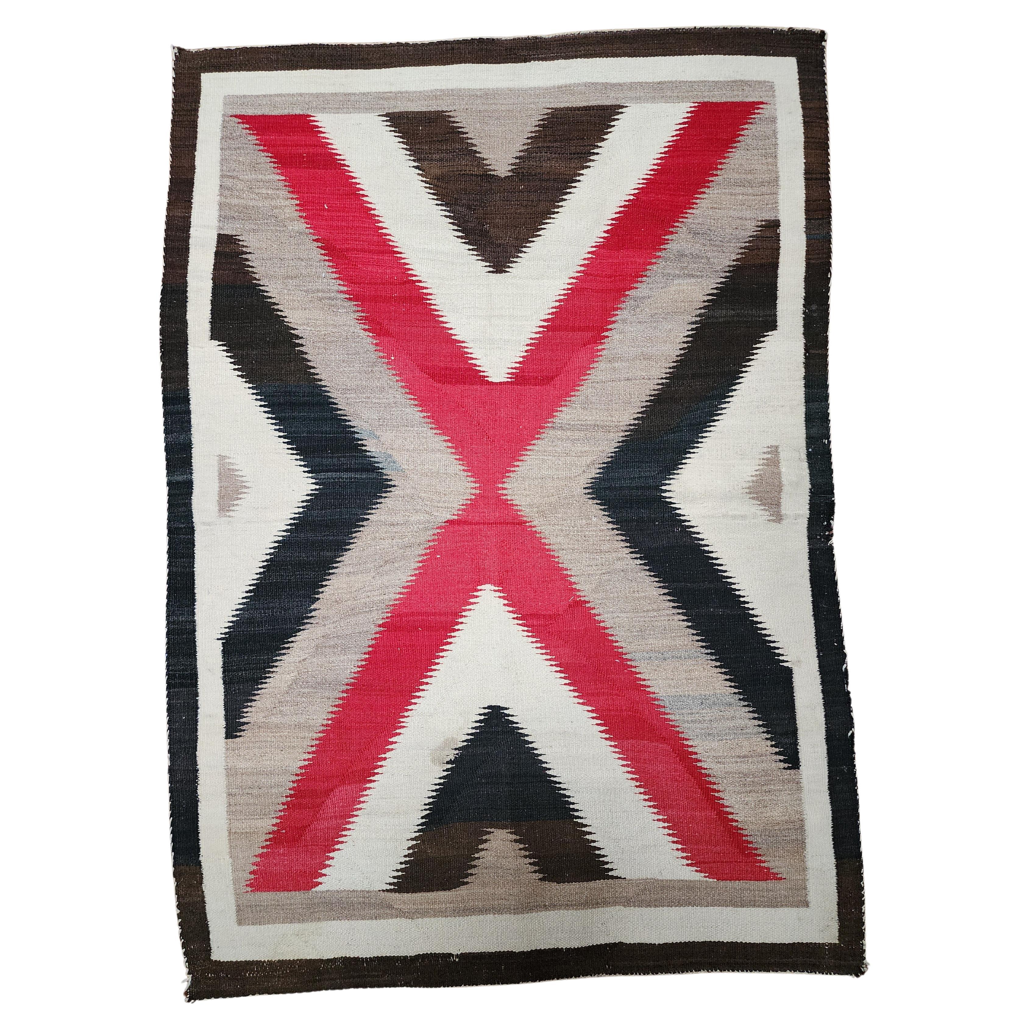 Circa 1890 Navajo weaving with a very elegant and modern design. Nice mottling of the natural colors, especially in the reds. This is a very bold weaving, likely a double saddle blanket. The gray threads seen in the neutral grounds are not a repair