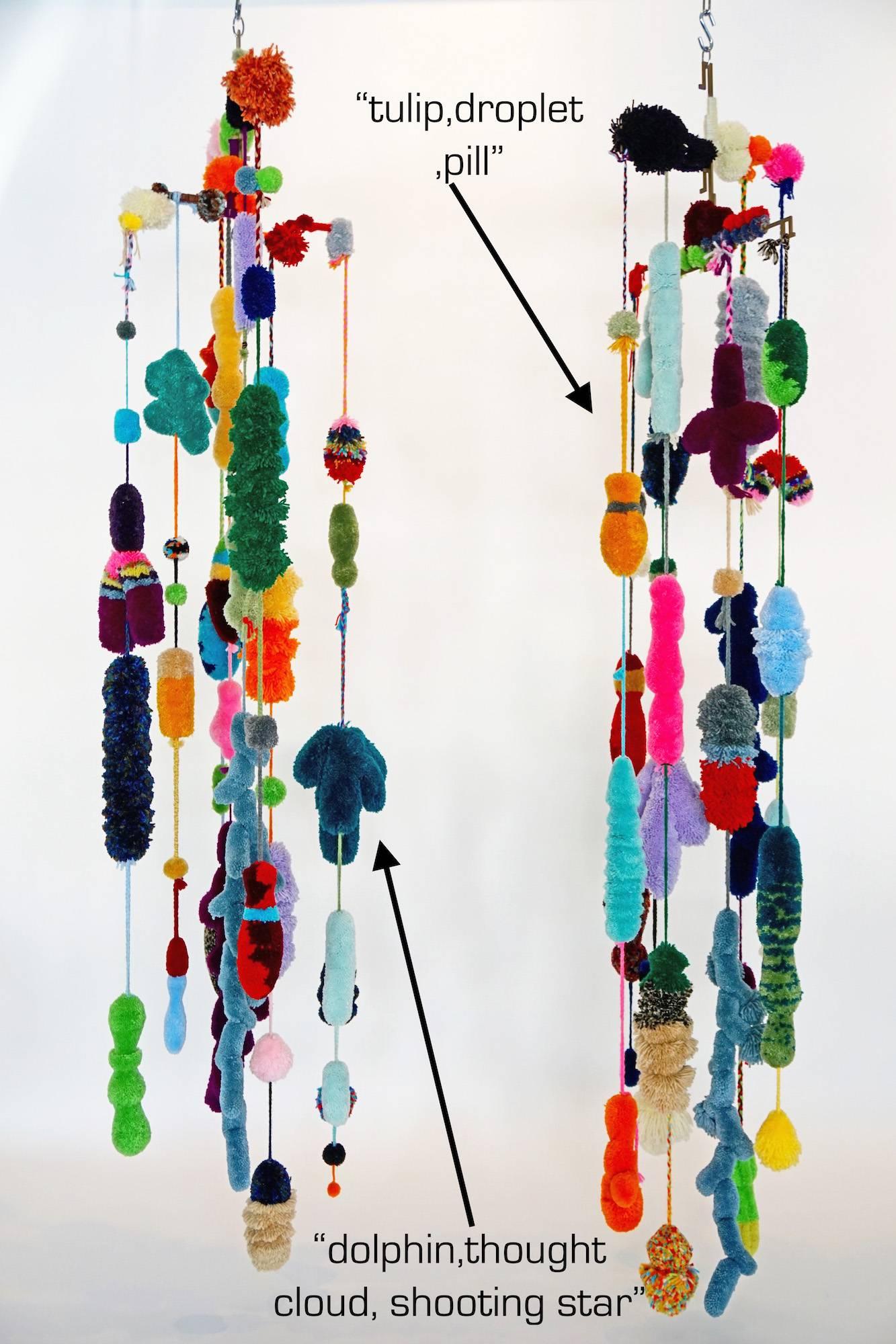 Strands of pom poms made with acrylic yarn and hand-cut profiles hung from water jet cut solid brass brackets by Mary Brogger.

Priced separately two available:
The one on the right is titled "tulip, droplet, pill."
The one on the left