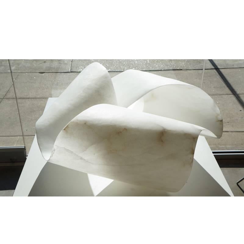 Monumental alabaster sculpture. An extraordinary piece, based on a Mobius strip, which has one edge and one surface. The alabaster from Volterra Tuscany is stunning, both in scale and translucency. Carved from a single block of alabaster, resulting