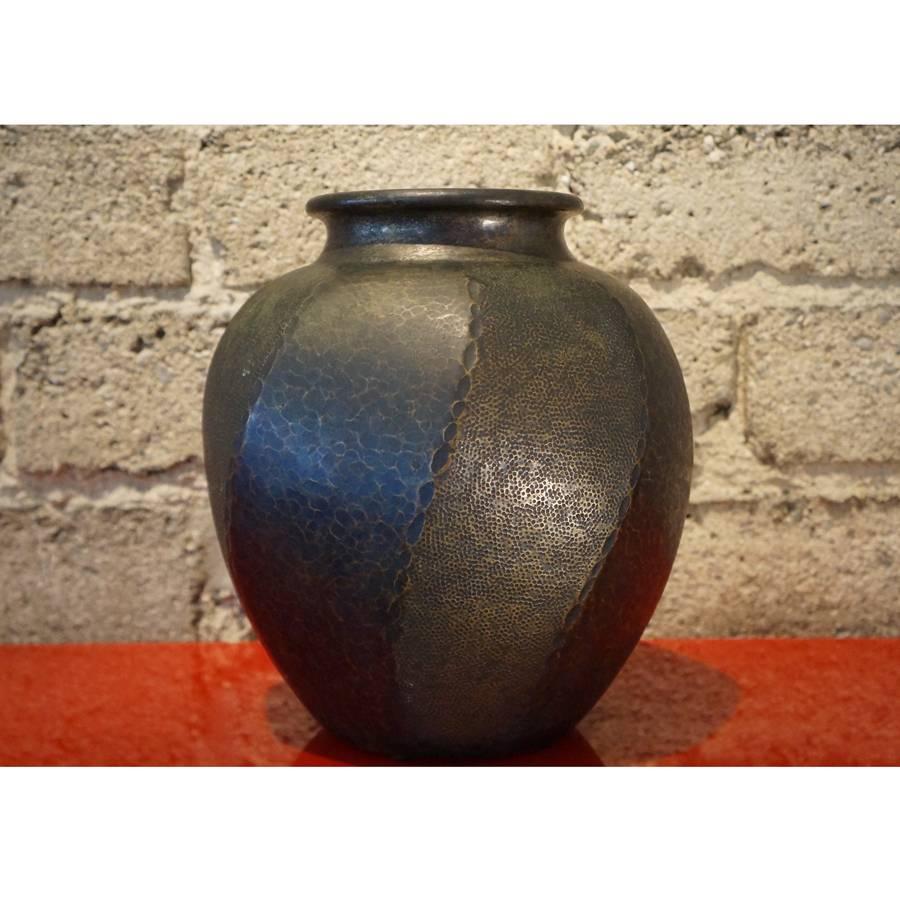 A beautiful hammered copper vase with a rich patina.

The artist of this decorative vase was a Tsuba maker. The hand guard of the sword. Typically embellished to some degree with surface texturing.
         