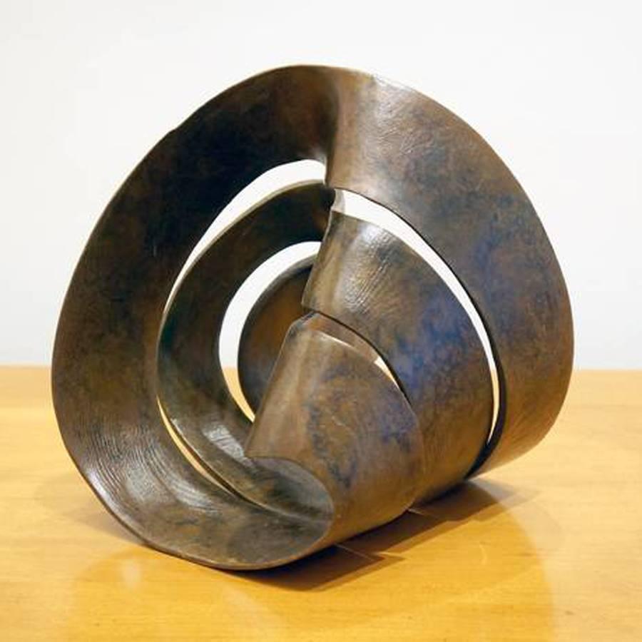 Bronze sculpture by Larry Frazier. Multi shaped possibilities ... a puzzle if you will.

I carved this piece originally in redwood – you can see the grain, captured in the bronze. My math teachers showed me what happens when you cut a mobius strip