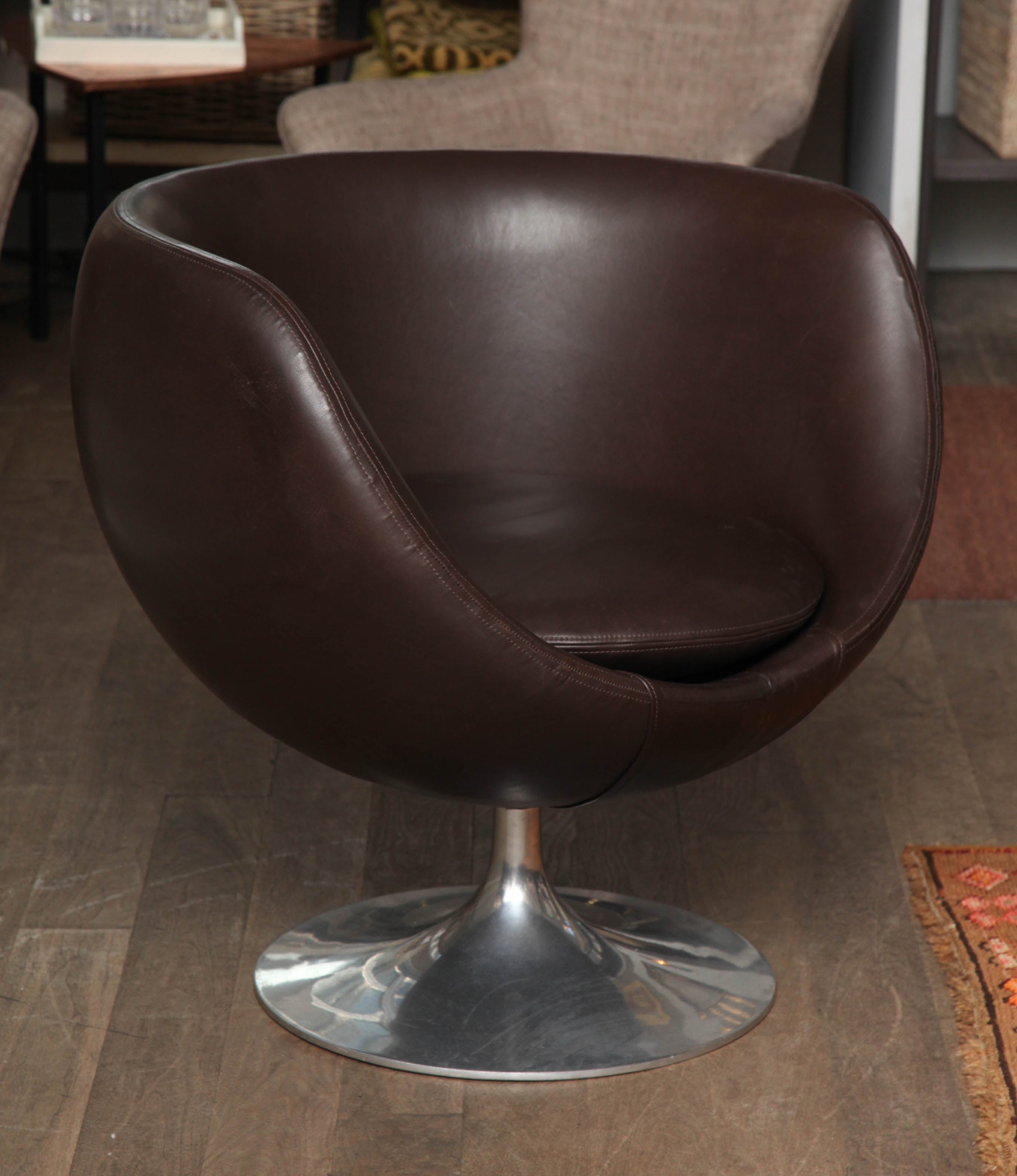 Pair of Overman style swivel pod chair on spun aluminum bases circa 1960 upholstered in brown plonge leather with saddle stitching