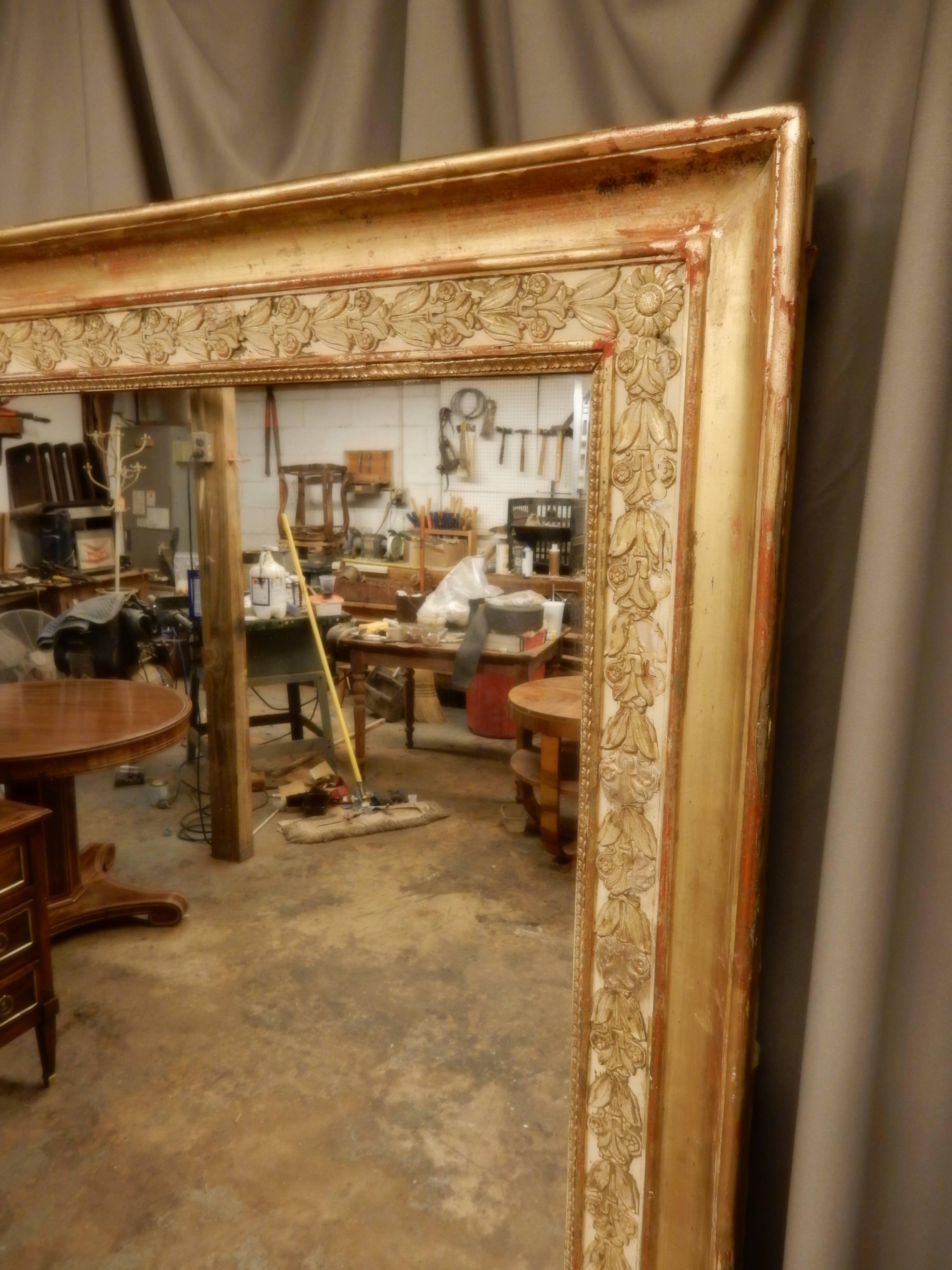Beautiful gilt early 19th century French mirror. Very delicate plaster relief decoration around frame. Mirror has been replaced sometime in the past.