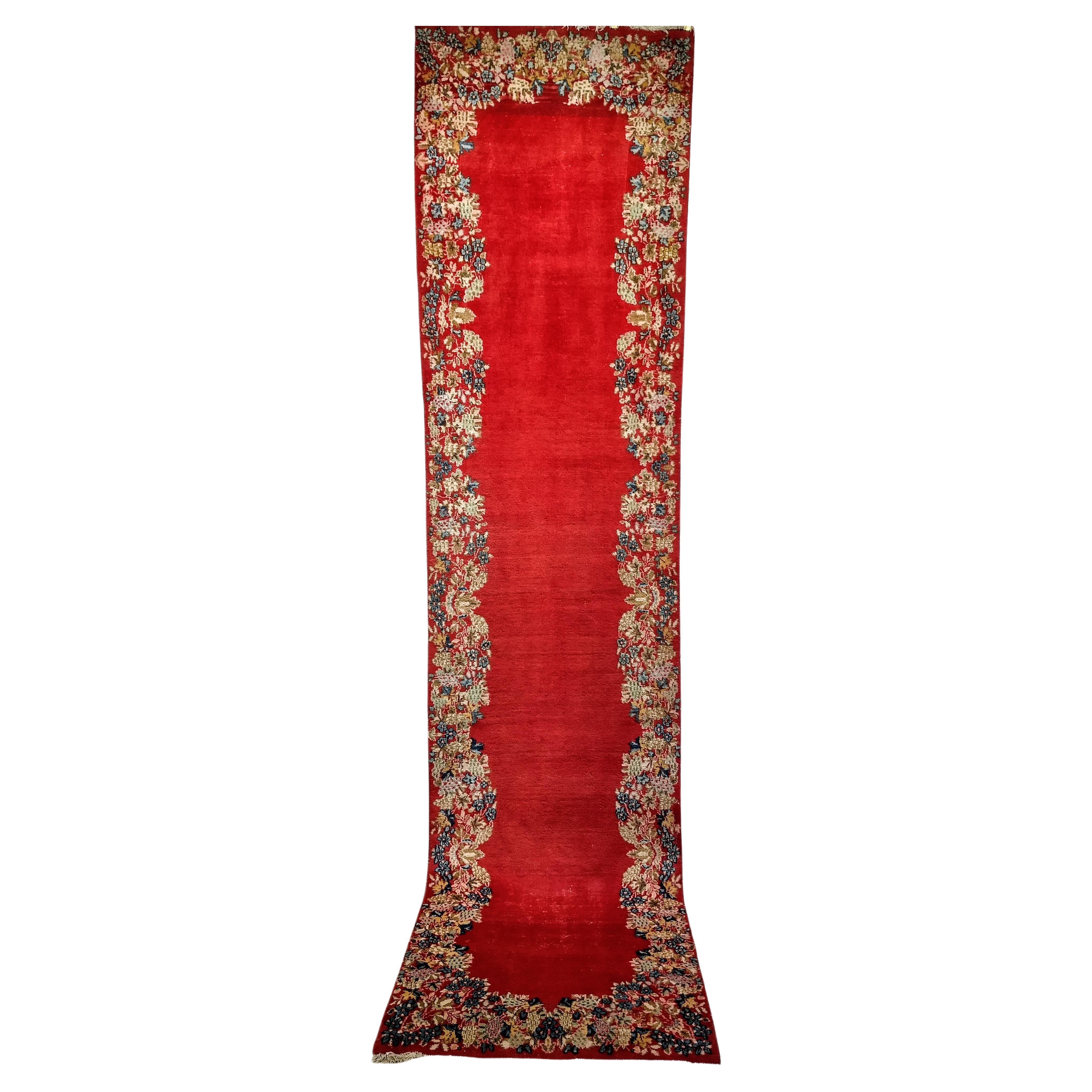  Vintage Persian Kerman Runner, an Open Field and Floral Bouquets Border Pattern.   Kerman rugs from southern Persia are desired for their use of floral bouquets in their designs. The city of Kerman, located as a major stop on the ancient silk road