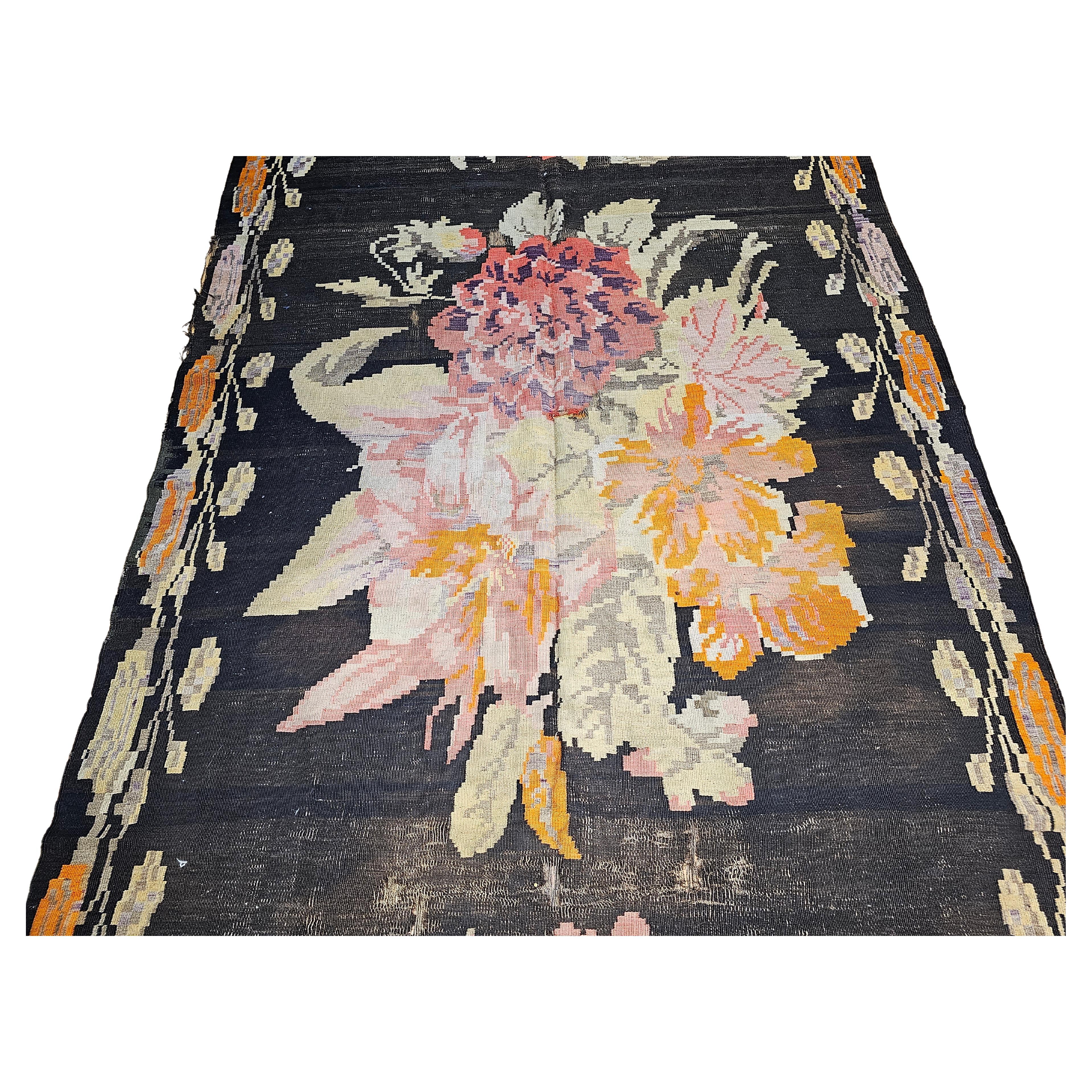The Vintage Caucasian Karabagh Kilim is one of the rarest kilims from the Caucasus region and much sought after.  The Karabagh kilim is a true masterpiece in design and color. Three large bouquets of flowers in a field of abrash (variegated color)