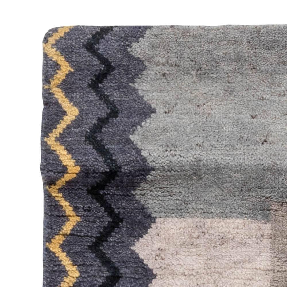 Angular forms, geometric patterns, bold colors - they are all enclosed in this intriguing Art Deco rug. This exquisite item is masterfully hand-executed of the best quality wool with the application of the traditional weaving techniques. Through